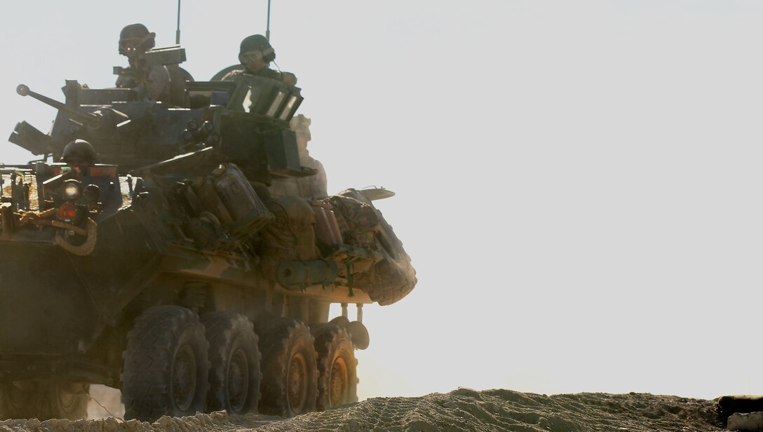 Marines with 3rd Light Armored Reconnaissance Battalion drive behind defensive lines during the Mechanized Assault Course at Range 210 Jan. 22, 2013.