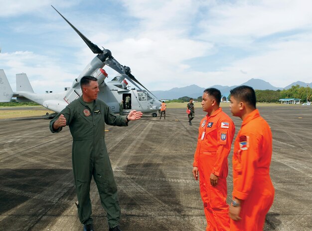 Maj. Joshua T. Fraser explains the capabilities of the MV-22B Osprey to members of the Philippine Air Force Jan. 23 at Antonio Bautista Air Base in Puerto Princesa, Palawan, Republic of the Philippines. Three Ospreys conducted low-altitude flight training Jan. 23 over Palawan, marking the Marine Corps' first Osprey training in the Philippines. PAF members accompanied Marines on the flights and provided ground control support for the Marines. Fraser is the operations officer for Marine Medium Tiltrotor Squadron 265, Marine Aircraft Group 36, 1st Marine Aircraft Wing, III Marine Expeditionary Force. (Photo by 1st Lt. Jeanscott Dodd)


