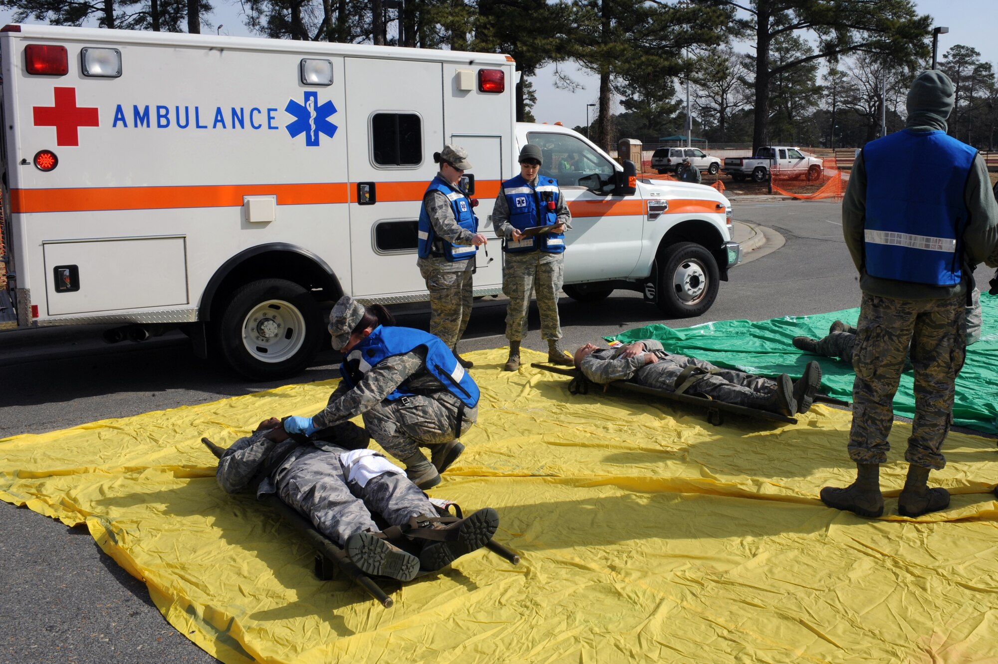 U.S. Air Force Airmen assigned to the 4th Fighter Wing administer first aid on moulage victims during an active shooter exercise on Seymour Johnson Air Force Base, N.C., Feb. 4, 2013. The training exercise pitted medical personnel into a real-life scenario, testing their response time and procedures. (U.S. Air Force photo/Airman 1st Class John Nieves Camacho/Released)