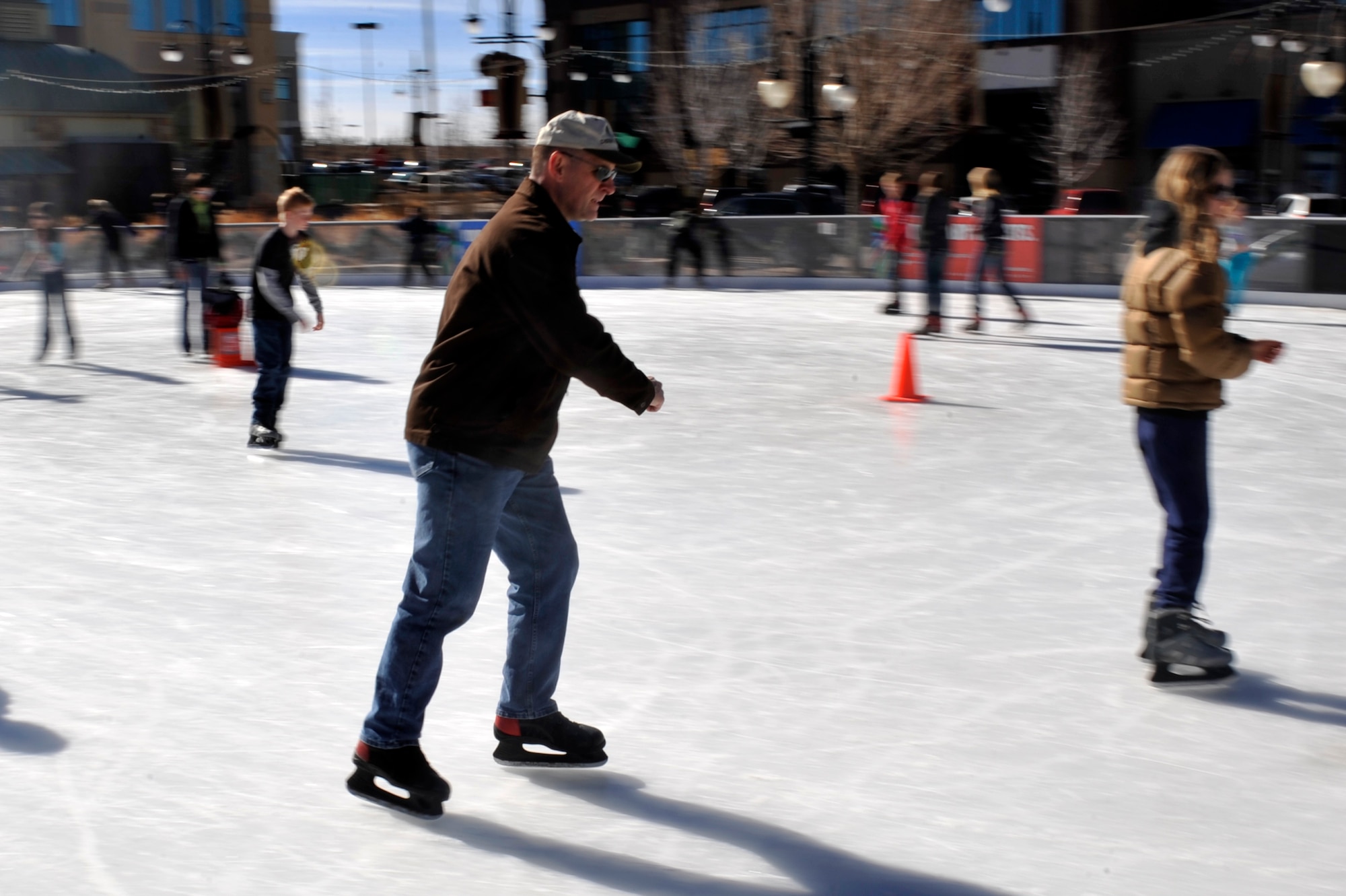 Lt. Col. Hew Wells, 460th Space Communications Squadron commander, skates during an event for families of deployed service members Feb. 2, 2013, at the Southlands Pond. Nearly 50 family members turned out for the free skating event hosted by the Airman and Family Readiness Center. (U.S. Air Force photo by Airman 1st Class Riley Johnson/Released)