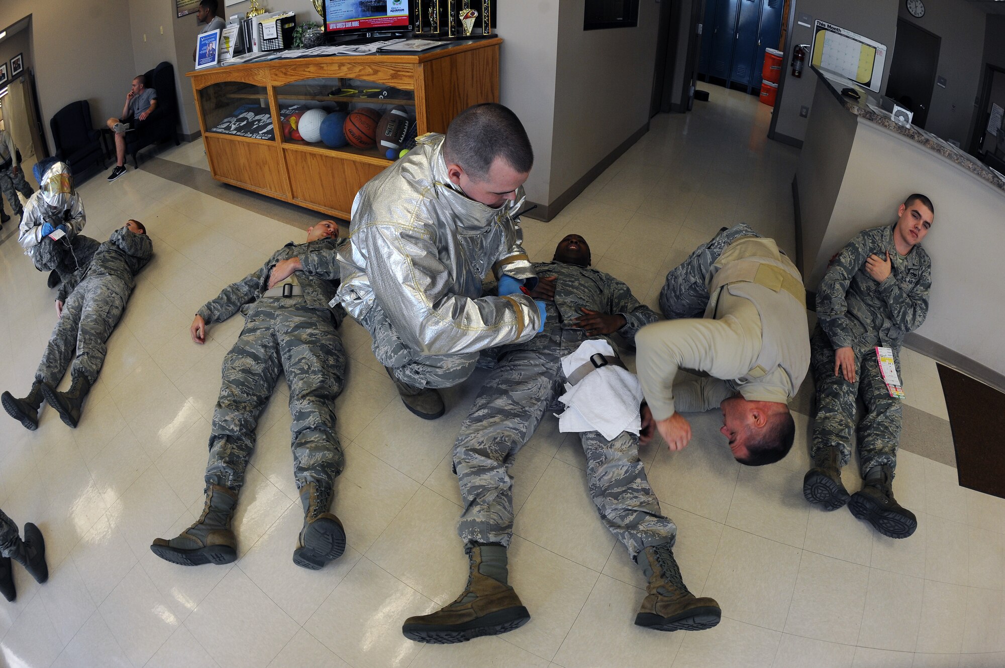 U.S. Air Force Airmen assigned to the 4th Fighter Wing conduct self aid buddy care procedures on moulage victims during an active shooter exercise on Seymour Johnson Air Force Base, N.C., Feb. 4, 2013. Security Forces, fire department and medical personnel were among those evaluated in the training exercise. (U.S. Air Force photo/Airman 1st Class John Nieves Camacho/Released)