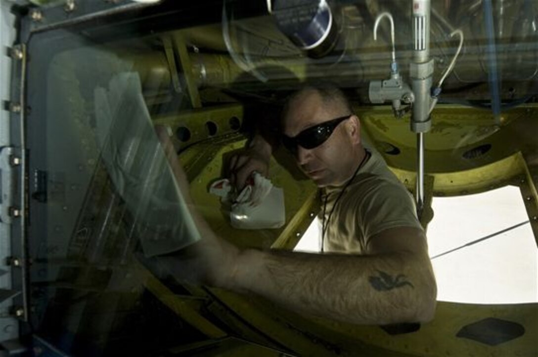 Staff Sgt. Sean Lowery cleans the boom operator’s window after a refueling mission during Exercise Red Flag 13-2 Jan. 22, 2013, at Nellis Air Force Base, Nev. Lowery cleans the window to ensure the boom operator has clear visibility of the boom and refueling jet when he connects during refueling operations. Lowery is assigned to the 22nd Aircraft Maintenance Squadron. (U.S. Air Force photo/Senior Airman Daniel Hughes)