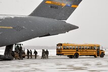 Air Force Reserve members assigned to the 76th Aerial Port Squadron (APS) place a shoring system next to a C-17, here, February 2. A shoring system is a ramp APS built to help put a school bus into the aircraft. U.S. Air Force photo by Tech. Sgt. Valerie Smock