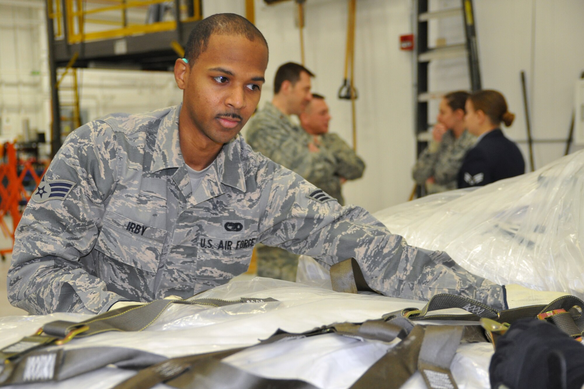 Air Force Reserve Senior Airman Donald J. Irby, an air transportation helper with 76th Aerial Port Squadron, ties down cargo to a pallet, here, February 2. The cargo is corn, which is going to Guatemala to help people in need. U.S. Air Force photo by Tech. Sgt.