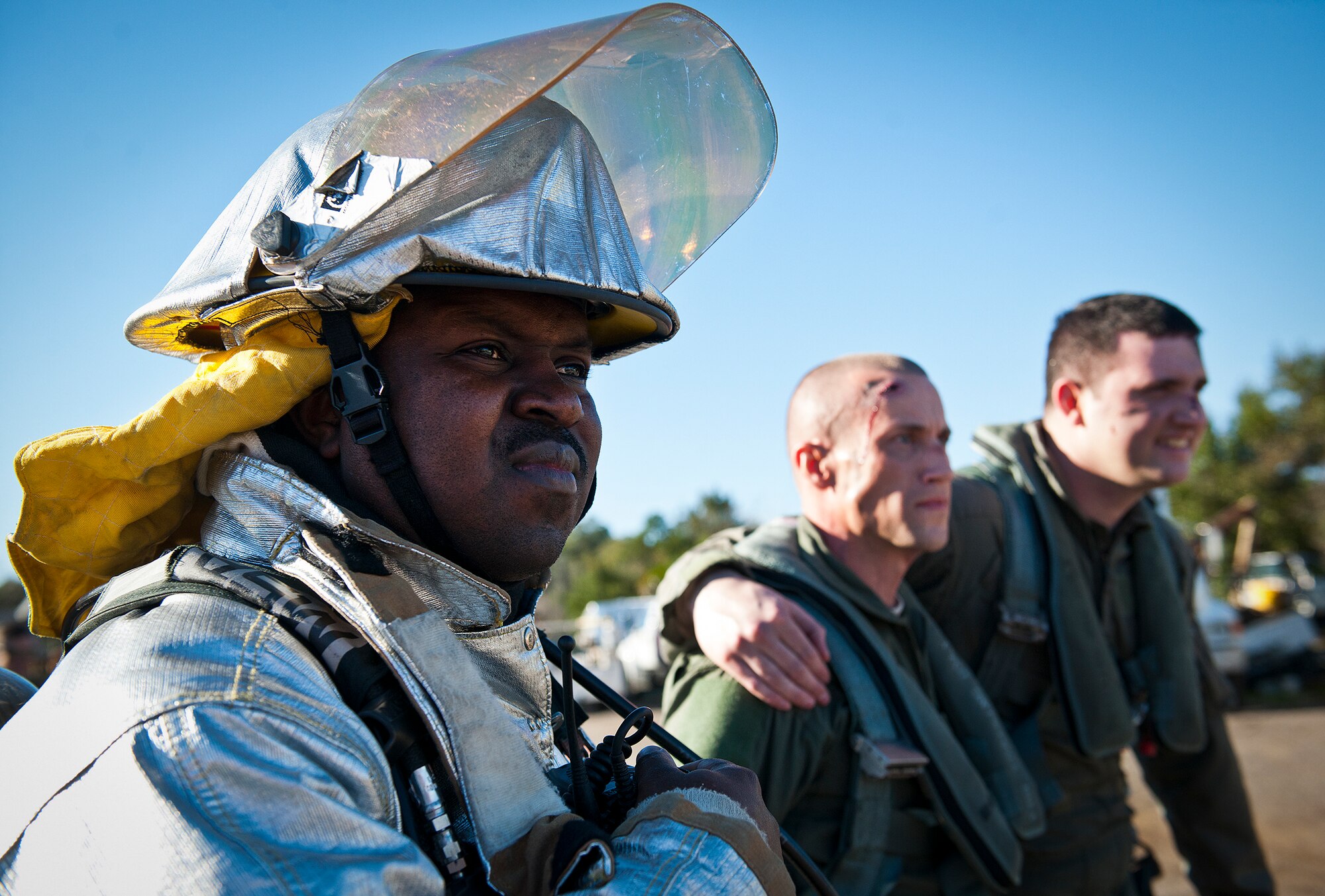 A 96th Civil Engineer Squadron firefighter waits for help with a simulated F-16 aircrew during a joint major accident response exercise between Eglin Air Force Base and Valparaiso Jan. 31.  Emergency responders from the base and the city were called to a downed aircraft scenario featuring fire, wreckage and victims with multiple injuries.  The responders had to work as a team and coordinate movements at the simulated crash site, put out fires and attend to the wounded victims.  (U.S. Air Force photo/Samuel King Jr.)