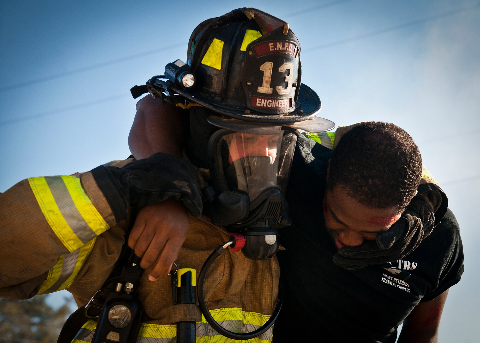 A Valparaiso firefighter moves a simulated victim to safety during a joint major accident response exercise between Eglin Air Force Base and the city Jan. 31.  Emergency responders from the base and the city were called to a downed aircraft scenario featuring fire, wreckage and victims with multiple injuries.  The responders had to work as a team and coordinate movements at the simulated crash site, put out fires and attend to the wounded victims.  (U.S. Air Force photo/Samuel King Jr.)