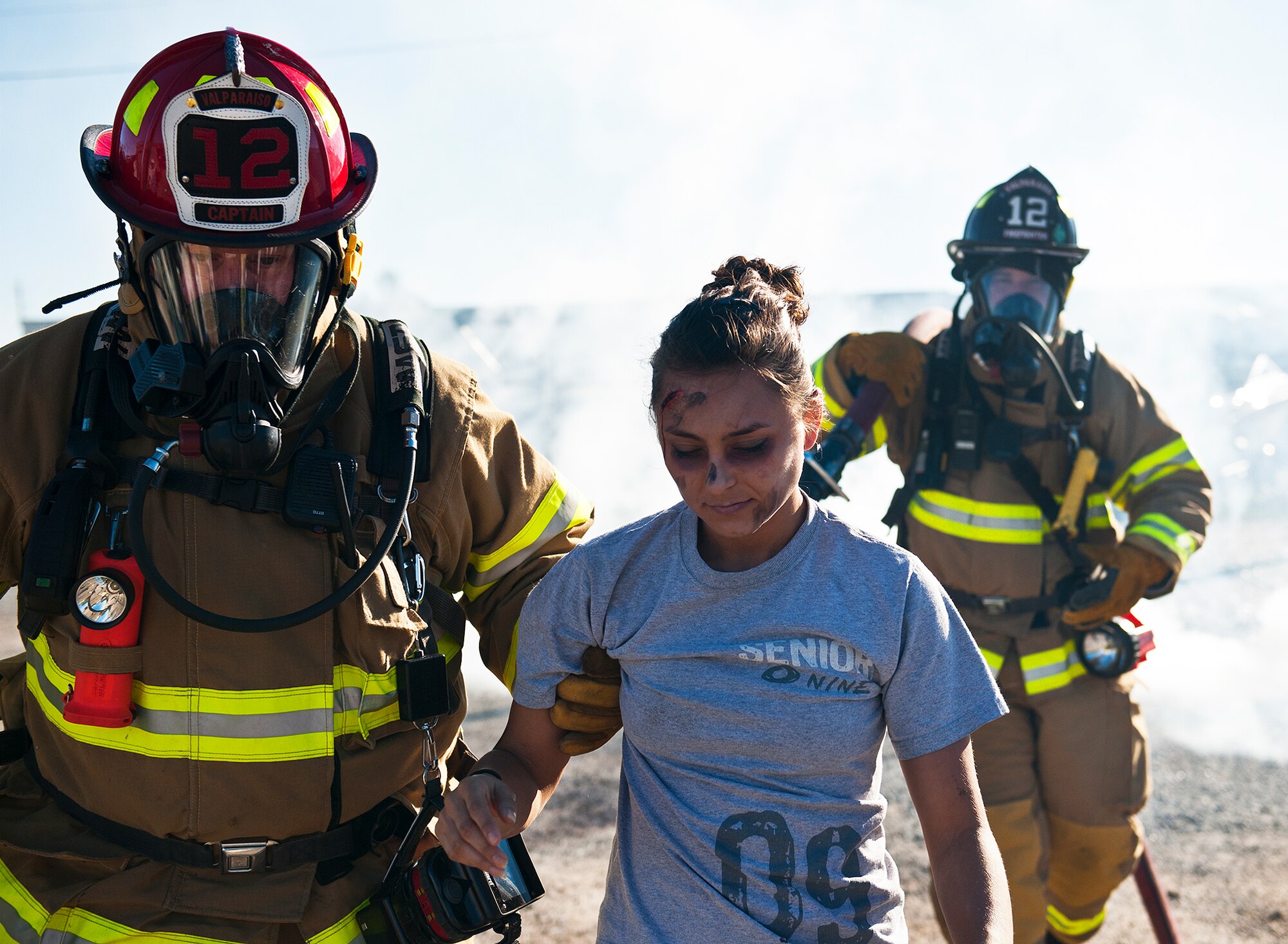 Valparaiso firefighters move a simulated victim as smoke rolls behind them during a joint major accident response exercise between Eglin Air Force Base and the city Jan. 31.  Emergency responders from the base and the city were called to a downed aircraft scenario featuring fire, wreckage and victims with multiple injuries.  The responders had to work as a team and coordinate movements at the simulated crash site, put out fires and attend to the wounded victims.  (U.S. Air Force photo/Samuel King Jr.)