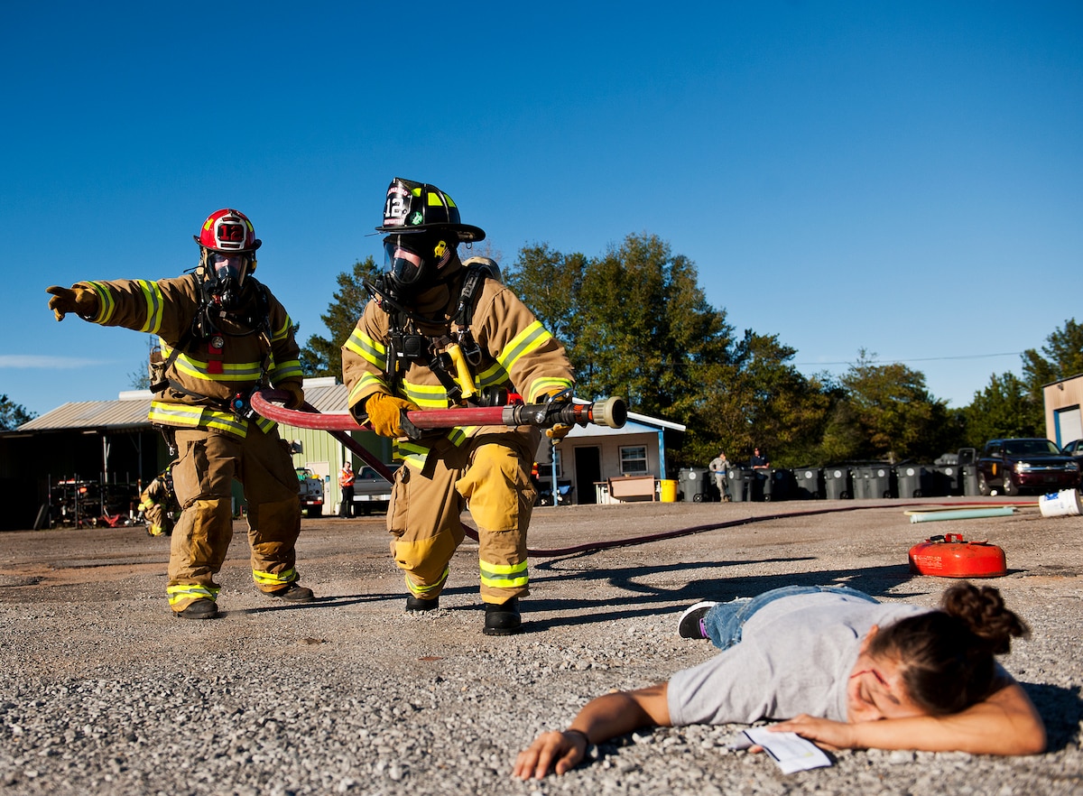 Valparaiso firefighters move toward the blaze and victims during a joint major accident response exercise between Eglin Air Force Base and the city Jan. 31.  Emergency responders from the base and the city were called to a downed aircraft scenario featuring fire, wreckage and victims with multiple injuries.  The responders had to work as a team and coordinate movements at the simulated crash site, put out fires and attend to the wounded victims.  (U.S. Air Force photo/Samuel King Jr.)