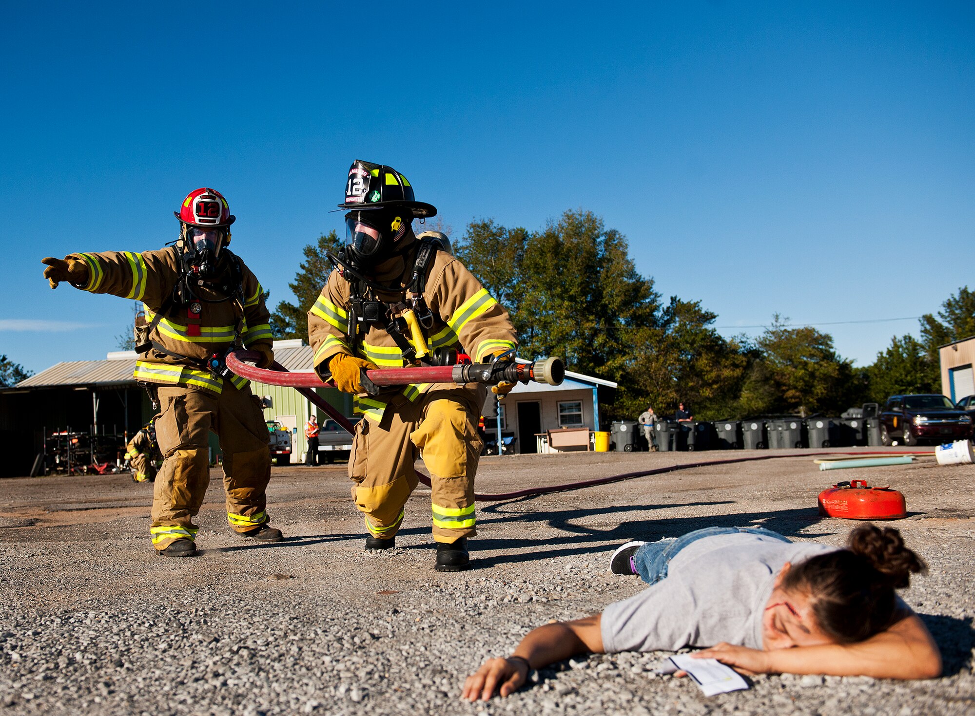Valparaiso firefighters move toward the blaze and victims during a joint major accident response exercise between Eglin Air Force Base and the city Jan. 31.  Emergency responders from the base and the city were called to a downed aircraft scenario featuring fire, wreckage and victims with multiple injuries.  The responders had to work as a team and coordinate movements at the simulated crash site, put out fires and attend to the wounded victims.  (U.S. Air Force photo/Samuel King Jr.)