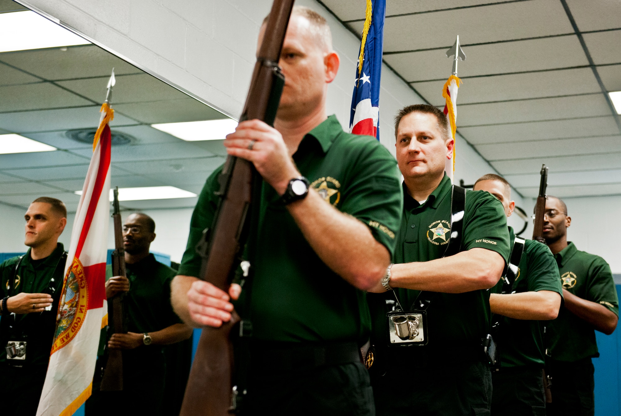 Members of the Okaloosa County Sheriff’s Office Honor Guard bring in the colors after being taught the Air Force way to carry flags and rifles at ceremonies by Eglin’s Honor Guard during a training session on base Feb. 1.  The OCSO team came together with Eglin’s honor guard to learn military protocols used during various ceremonies such as retirements, funerals, etc.  This was the first of many proposed training sessions between the two teams.  (U.S. Air Force photo/Samuel King Jr.)