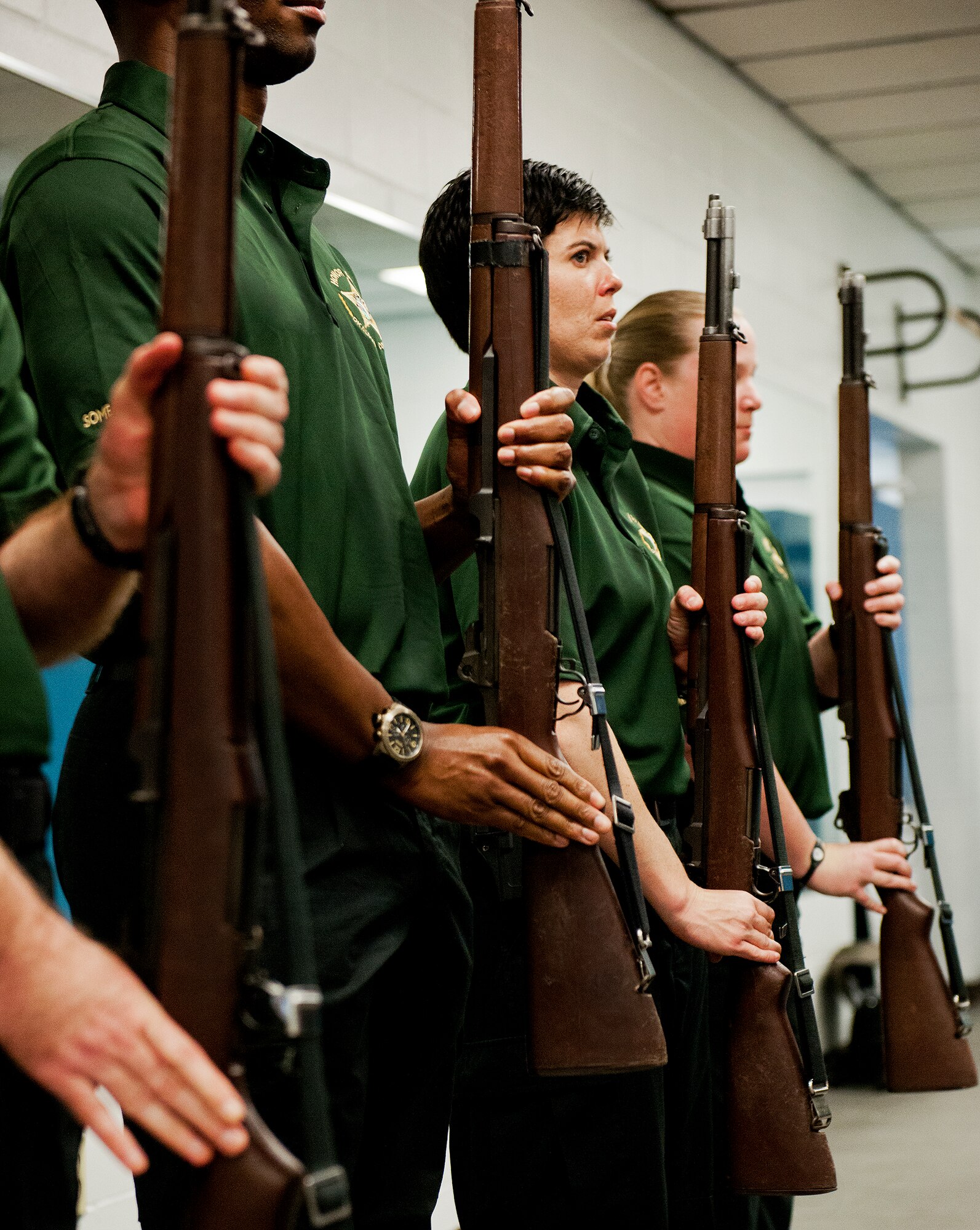 Deputy Kelly Henderson, of the Okaloosa County Sheriff’s Office Honor Guard, watches a Team Eglin Honor Guard member for the next movement during a training session at Eglin Air Force Base, Fla., Feb. 1.  The OCSO team came together with Eglin’s honor guard to learn military protocols used during various ceremonies such as retirements, funerals, etc.  During this first training session Eglin’s Airmen taught them proper movements while carrying flags and rifles.  This was the first of many proposed training sessions between the two teams.  (U.S. Air Force photo/Samuel King Jr.)