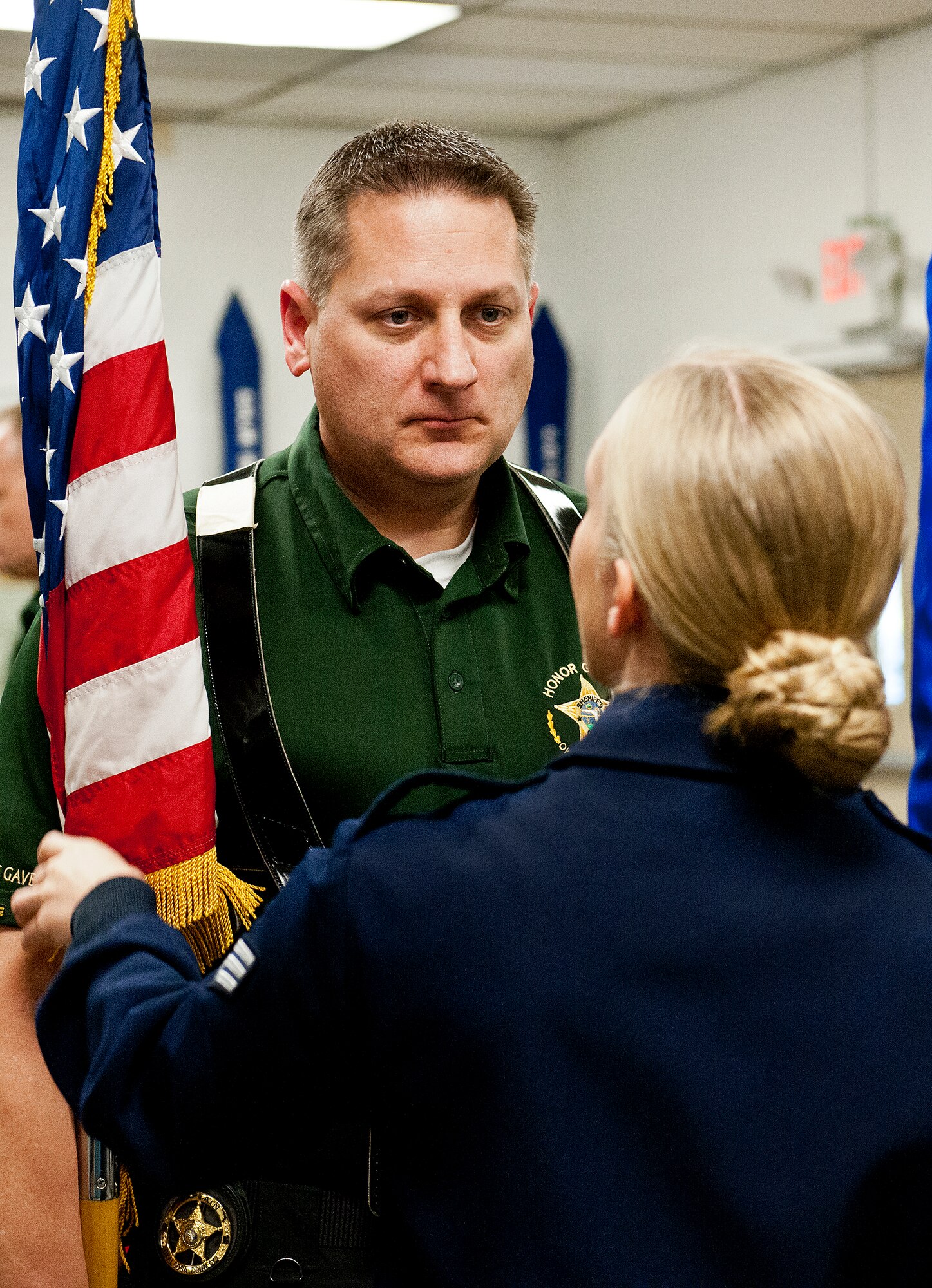 Senior Airman Mehgan Evans, a trainer with the Team Eglin Honor Guard, shows Capt. Kenneth LaPee, of the Okaloosa County Sheriff’s Office Honor Guard, the Air Force way of holding and moving a flag during a training session on base Feb. 1.  The OCSO team came together with Eglin’s honor guard to learn military protocols used during various ceremonies such as retirements, funerals, etc.  During this first training session Eglin’s Airmen taught them proper movements while carrying flags and rifles.  This was the first of many proposed training sessions between the two teams.  (U.S. Air Force photo/Samuel King Jr.)