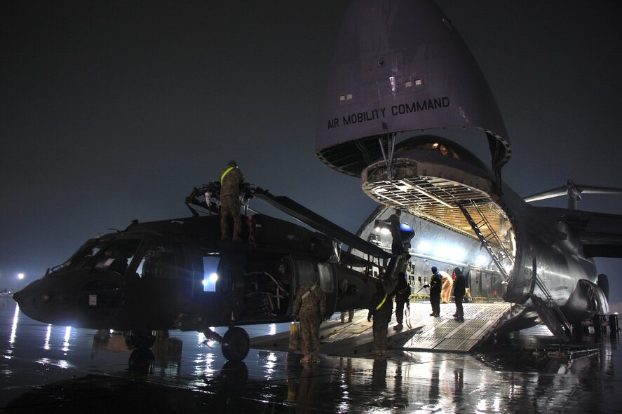 Soldiers and Airmen offload a UH-60 Black Hawk helicopter from a C-5M Super Galaxy at Bagram Air Field. The C-5M Super Galaxy has served the U.S. Air Force since 1969, and continues to provide vital heavy air lift to troops worldwide. (U.S. Army photo/1st Lt. Henry Chan, 18th Combat Sustainment Support Battalion Public Affairs) 
