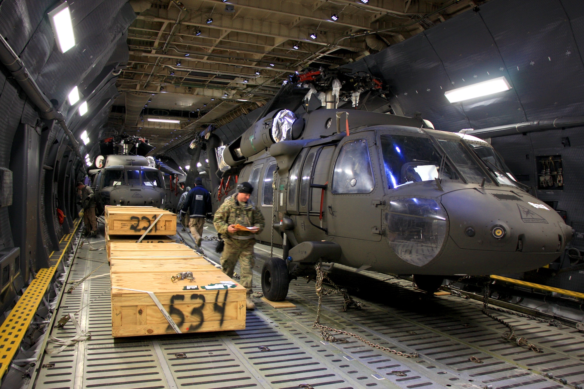 UH-64 Black Hawk helicopters await offload from a C-5M Super Galaxy at Bagram Air Field. The C-5M Super Galaxy has served the U.S. Air Force since 1969, and continues to provide vital heavy air lift to troops worldwide. (U.S. Army photo/1st Lt. Henry Chan, 18th Combat Sustainment Support Battalion Public Affairs)