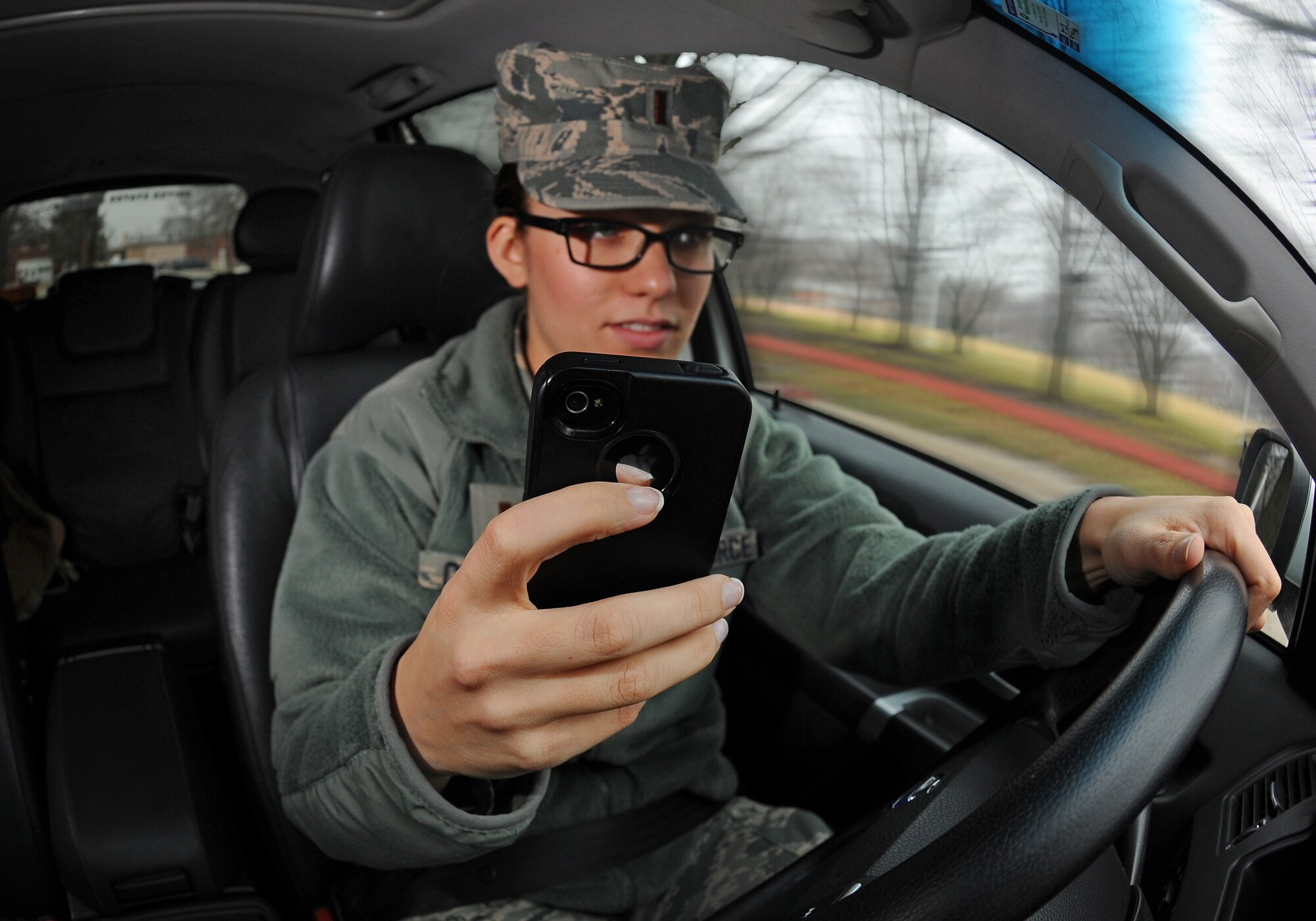One temptation while driving is the cellular phone. Remember, DoD instruction 6055.04 and Offutt policy states that only hands free devices can be used while driving. (Photo illustration by 2nd Lt. Carly Costello and Josh Plueger)