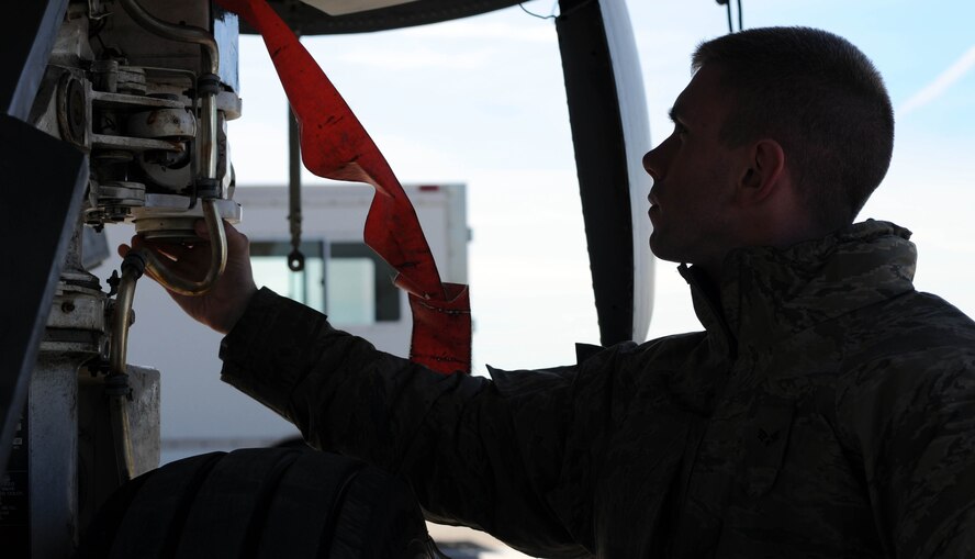 Senior Airman Kyle Nickels, a KC-135 crew chief from the 100th Aircraft Maintenance Squadron, RAF Mildenhall, England, inspects the landing gear on a jet after a mission over Africa Feb. 3, 2013. Airmen from RAF Mildenhall deployed to southwest Europe in January to support French operations in Mali. (U.S. Air Force photo by Staff Sgt. Austin M. May)