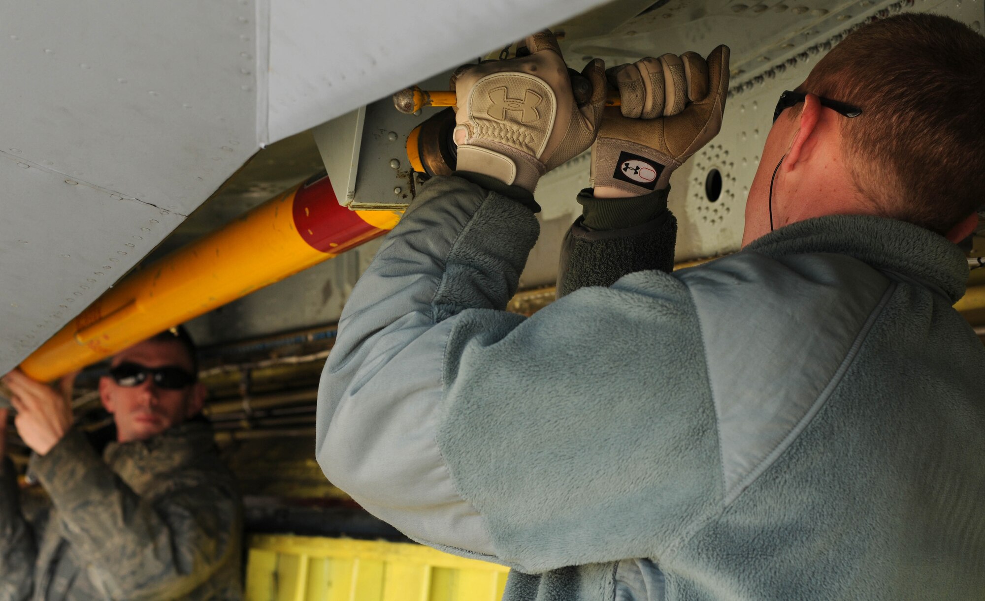 Airman 1st Class Colton Williams (foreground) and Senior Airman Kyle Nickels, KC-135 crew chiefs from the 100th Aircraft Maintenance Squadron, RAF Mildenhall, England, remove gear necessary for post-flight recovery procedures on a jet after a mission over Africa Feb. 3, 2013. Airmen from RAF Mildenhall deployed to southwest Europe in January to support French operations in Mali. (U.S. Air Force photo by Staff Sgt. Austin M. May)