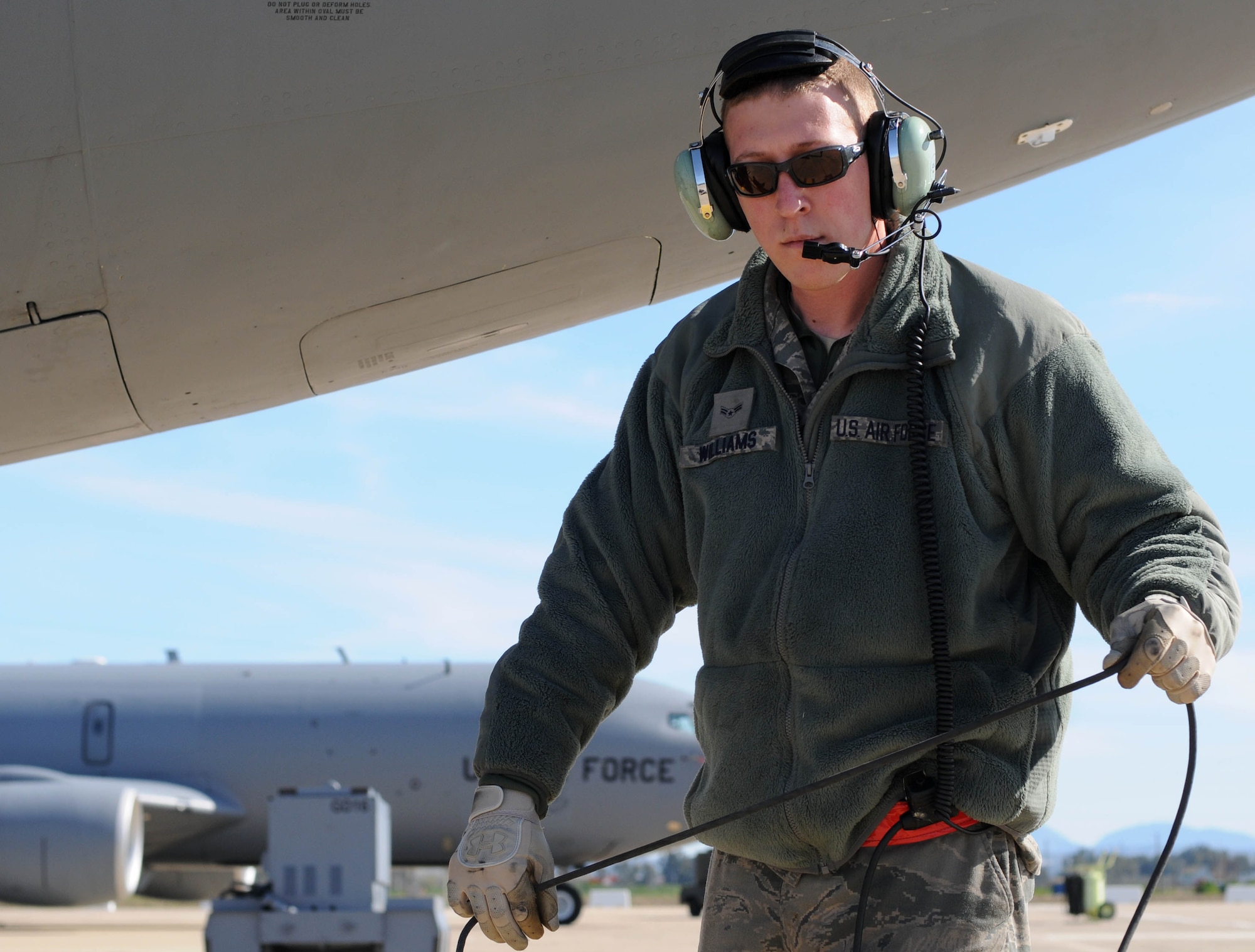 Airman 1st Class Colton Williams, a KC-135 crew chief from the 100th Aircraft Maintenance Squadron, RAF Mildenhall, England, talks to the crew of a jet through his headset after a mission over Africa Feb. 3, 2013. Airmen from RAF Mildenhall deployed to southwest Europe in January to support French operations in Mali. (U.S. Air Force photo by Staff Sgt. Austin M. May)