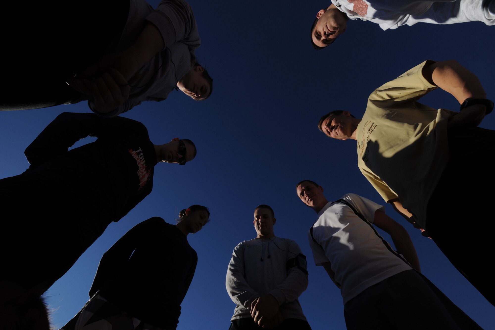 CREECH AIR FORCE BASE, Nev. - Airmen with the Creech AFB Fallen Warriors Memorial Club pause for a moment of silence before a two-mile run during their weekly training session Jan. 30. The club hosts runs to build endurance and speed and to help members prepare for their AF fitness assessment. (U.S. Air Force photo by Staff Sgt. Nadine/RELEASED)