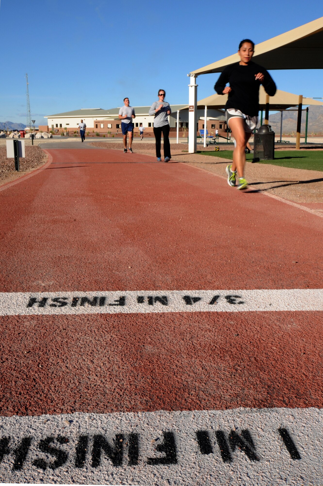CREECH AIR FORCE BASE, Nev. - Airmen with the Creech AFB Fallen Warriors Memorial Club, race to the finishline during their weekly training session, Jan. 30. The club hosts runs to build endurance and speed to help members prepare for their AF fitness assessment. (U.S. Air Force photo by Staff Sgt. Nadine/RELEASED)