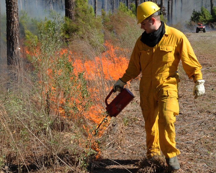 Airman 1st Class Daniel Howard, 2nd Civil Engineer Squadron firefighter, sets a boundary line during a prescribed burn on Barksdale Air Force Base, La., Jan. 31. The line is used to help contain the fire within a specific area. (U.S. Air Force photo/Senior Airman Sean Martin)