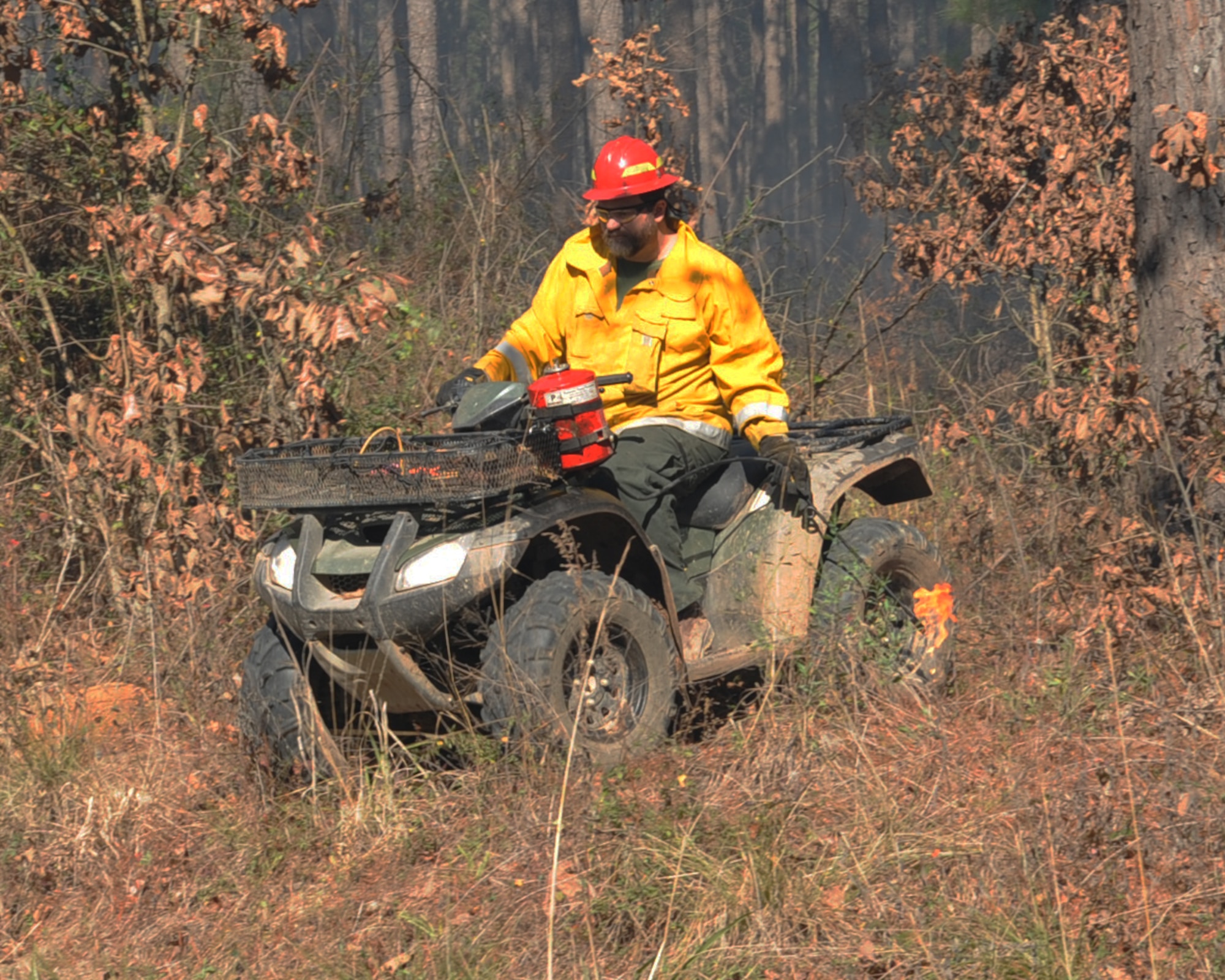 Mark Gates, 2nd Civil Engineer Squadron wildlife biologist, sets a boundary line during a prescribed burn on Barksdale Air Force Base, La., Jan. 31. The line is used to help contain the fire within a specific area. (U.S. Air Force photo/Senior Airman Sean Martin)