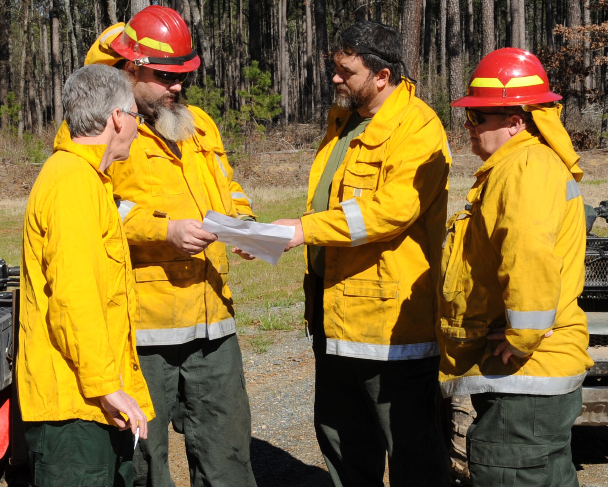 Members from the 2nd Civil Engineer Squadron natural resources office look at a map of the East Reservation during a prescribed burn on Barksdale Air Force Base, La., Jan. 31. The burn will help decrease the chance of a wildfire and also allow the wildlife to flourish. (U.S. Air Force photo/Senior Airman Sean Martin)