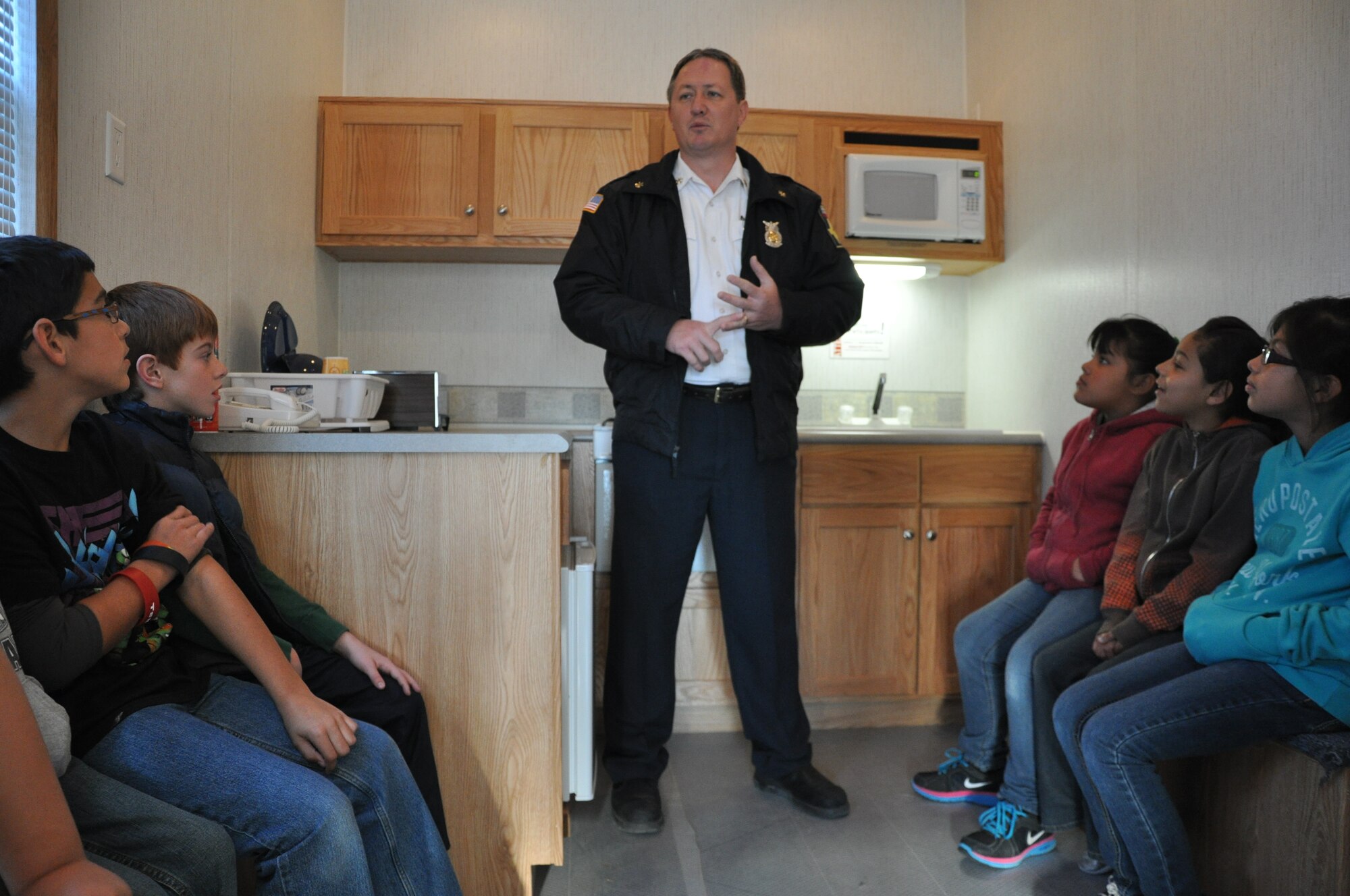 GOODFELLOW AIR FORCE BASE, Texas- Glenn Haffner, 17th Civil Engineer Squadron assistant chief, talks about fire safety in the kitchen to 3rd-grade students at Eldorado Elementary School in Eldorado, Texas, Jan. 30. Members from the 17th CES brought the mobile fire safety house out to the elementary school to teach students about home fire prevention. (U.S. Air Force photo/ Airman 1st Class Erica Rodriguez) 