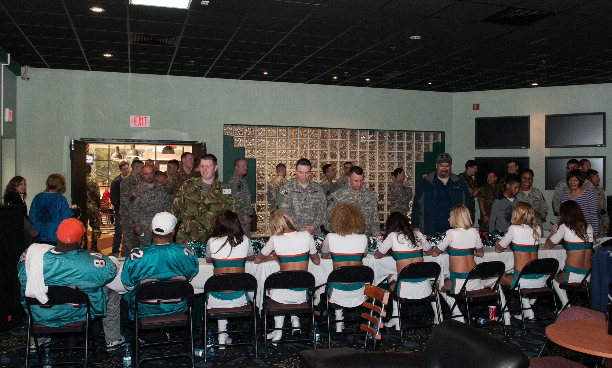 Members of the Miami Dolphins cheerleading squad sign autographs and take photos with Incirlik patrons at Big City Bowling, Jan. 30, 2013 at Incirlik Air Base, Turkey. The cheerleaders, along with two Miami Dolphins alumni Troy Drayton and Shawn Wooden, visited Incirlik as part of the Armed Forces Entertainment Super Bowl Tour. The cheerleaders and football players made several appearances around the base, including a radio show with the Incirlik American Forces Network, a cheer and football clinic, and a performance at the Youth Center. (U.S. Air Force by Staff Sgt. Veuril McDavid/Released)
