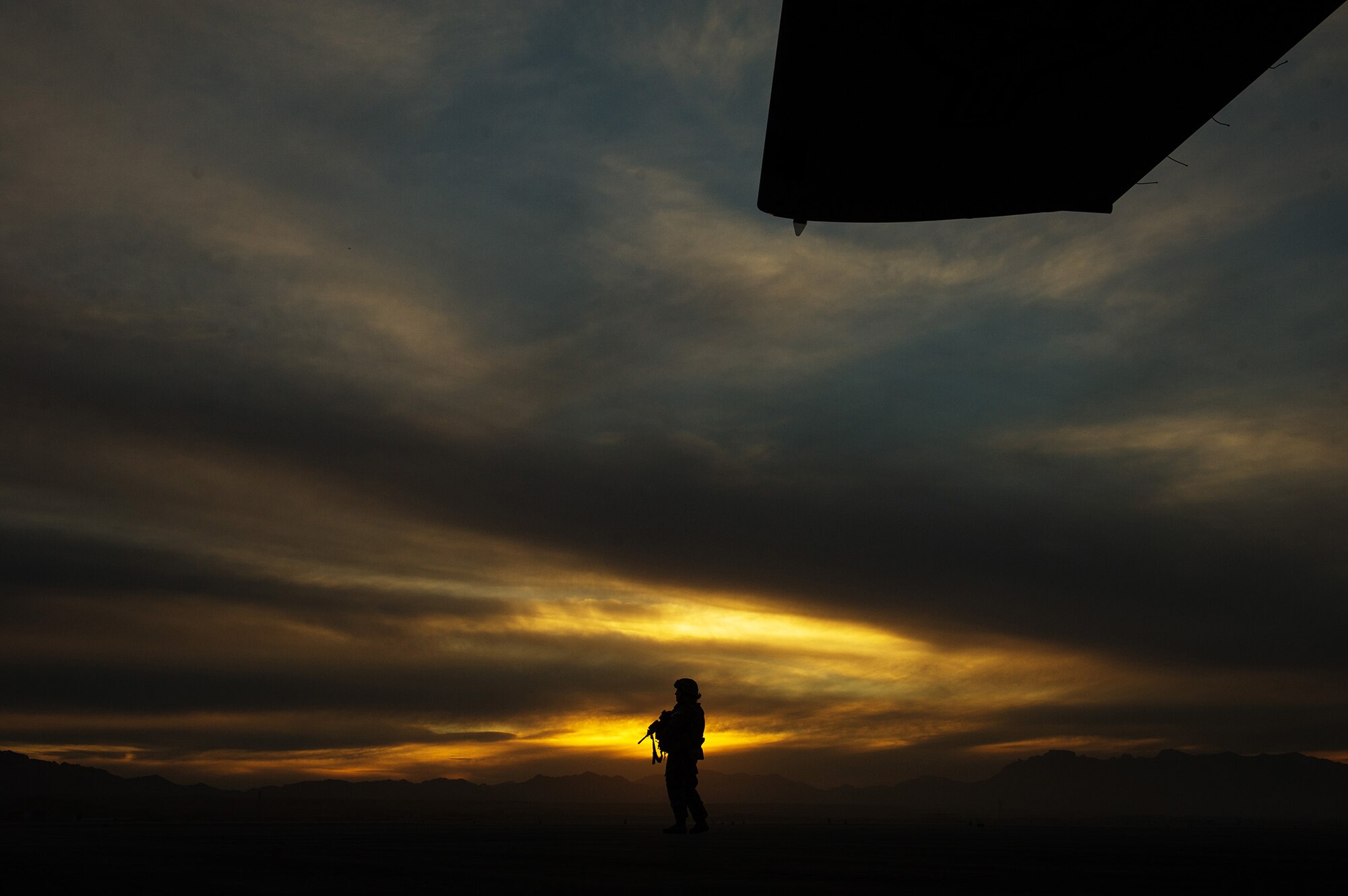 U.S. Air Force Senior Airman Bambi White, 451st Expeditionary Security Forces Squadron, provides security of a U.S. Air Force C-130J Super Hercules Dec. 5, 2012, at a forward operating base in Afghanistan. When an aircraft lands at locations with little to no security on the landing strip, fly-away security teams come along to provide additional protection for the aircraft and crew. White's hometown is Pontoon Beach, Ill. (U.S. Air Force photo/Staff Sgt. Jonathan Snyder)