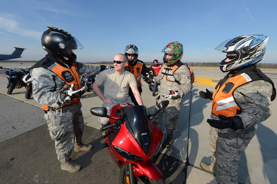Never let your wingman down. That's the approach seen here as motorcycle riders at Dover Air Force Base, Del. gently persuade Staff Sgt. Shaun Bond to don his safety gear before a ride. Members of the 436th Airlift Wing ride safely at Dover Air Force Base, Del. USAF photo/Greg L. Davis