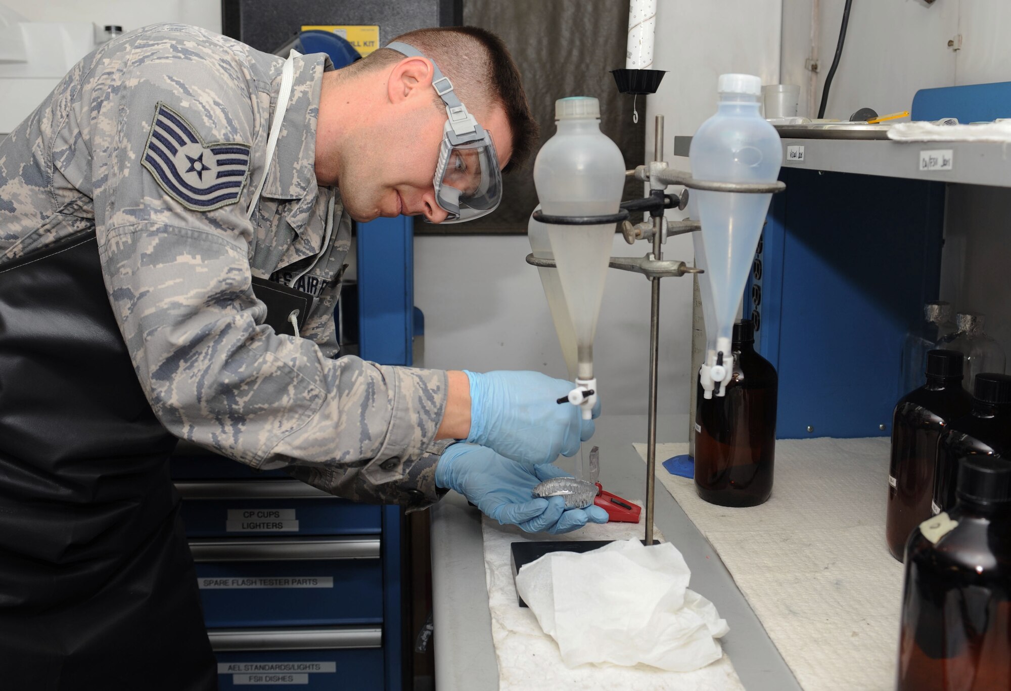 Tech. Sgt. Ronald Gasper, 376th Expeditionary Logistics Readiness Squadron fuels laboratory NCO in charge, extracts icing inhibitors from a fuel sample Feb. 4, 2013, at Transit Center at Manas, Kyrgyzstan.  Gasper tests approximately 120 fuel samples a month. Gasper is deployed from Scott Air Force Base, Ill., and is a native of Omaha, Neb.  (U.S. Air Force photo/Staff Sgt. Stephanie Rubi)