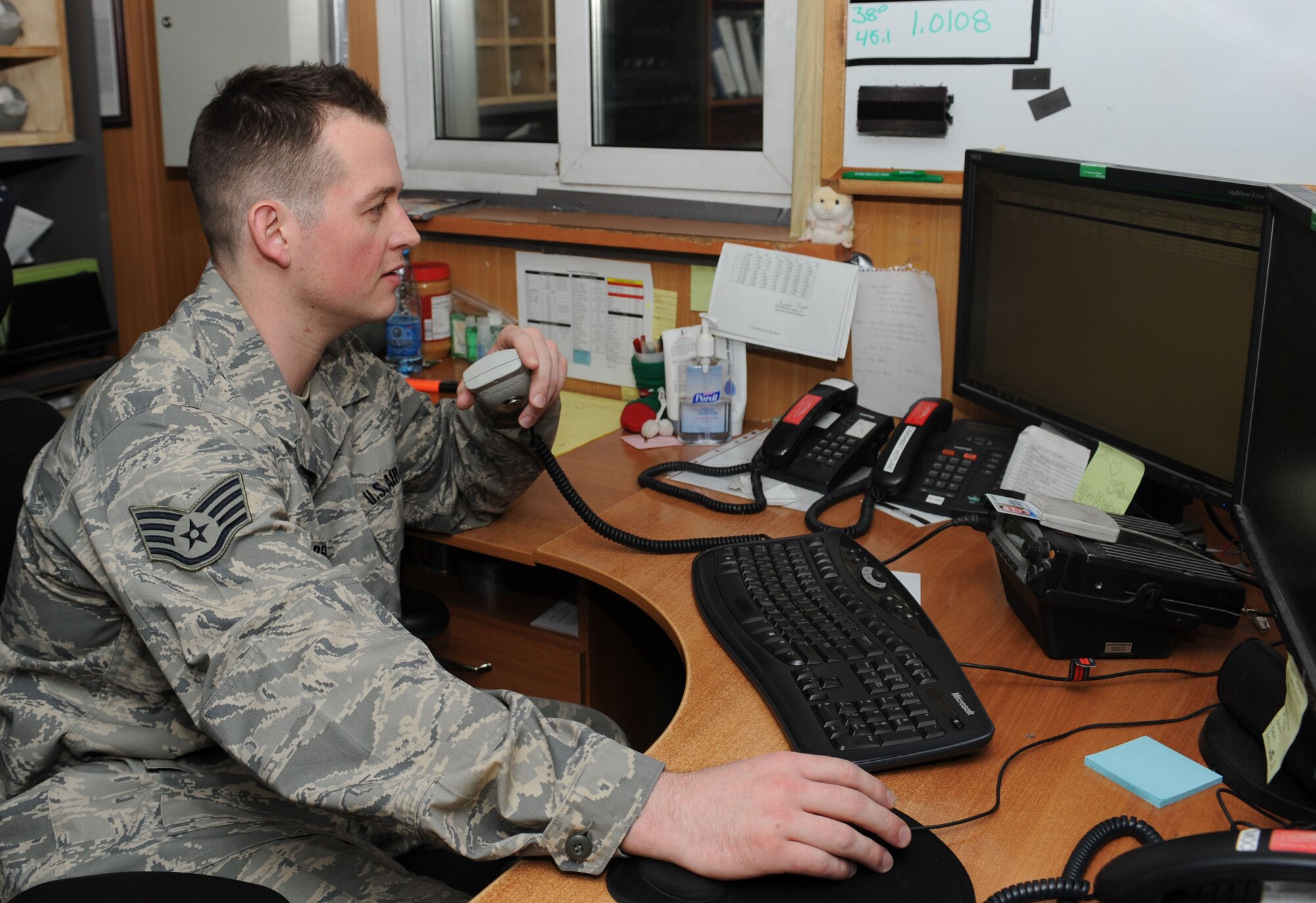Staff Sgt. John Penick, 376th Expeditionary Logistics Readiness Squadron fuels service center controller, keeps in constant contact with several Airmen within the petroleum, oils and lubricants flight Feb. 4, 2013, at Transit Center at Manas. Penick receives calls throughout the day from customers requesting fuel; he also receives calls on order updates from Airmen within the flight. Penick is deployed from Yokota Air Base, Japan, and is a native of Roanoke, Va.  (U.S. Air Force photo/Staff Sgt. Stephanie Rubi)