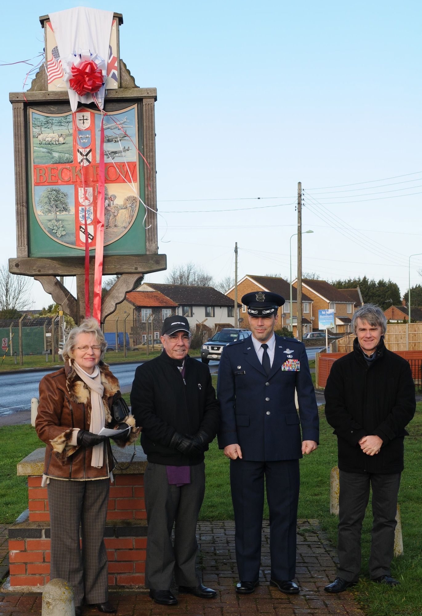 From left, Kay Sallis, chairman of Beck Row, Holywell Row and Kenny Hill Parish Council, Ken Thompson, British-American Committee chairman, Col. Christopher Kulas, 100th Air Refueling Wing commander, and Gary Rogers, 100th ARW Public Affairs graphic artist, unveil the new Beck Row sign Feb. 2, 2013, at Beck Row, England. The new sign symbolizes the unity between RAF Mildenhall and the local community.  (U.S. Air Force photo by Master Sgt. Latisha Cole/Released)