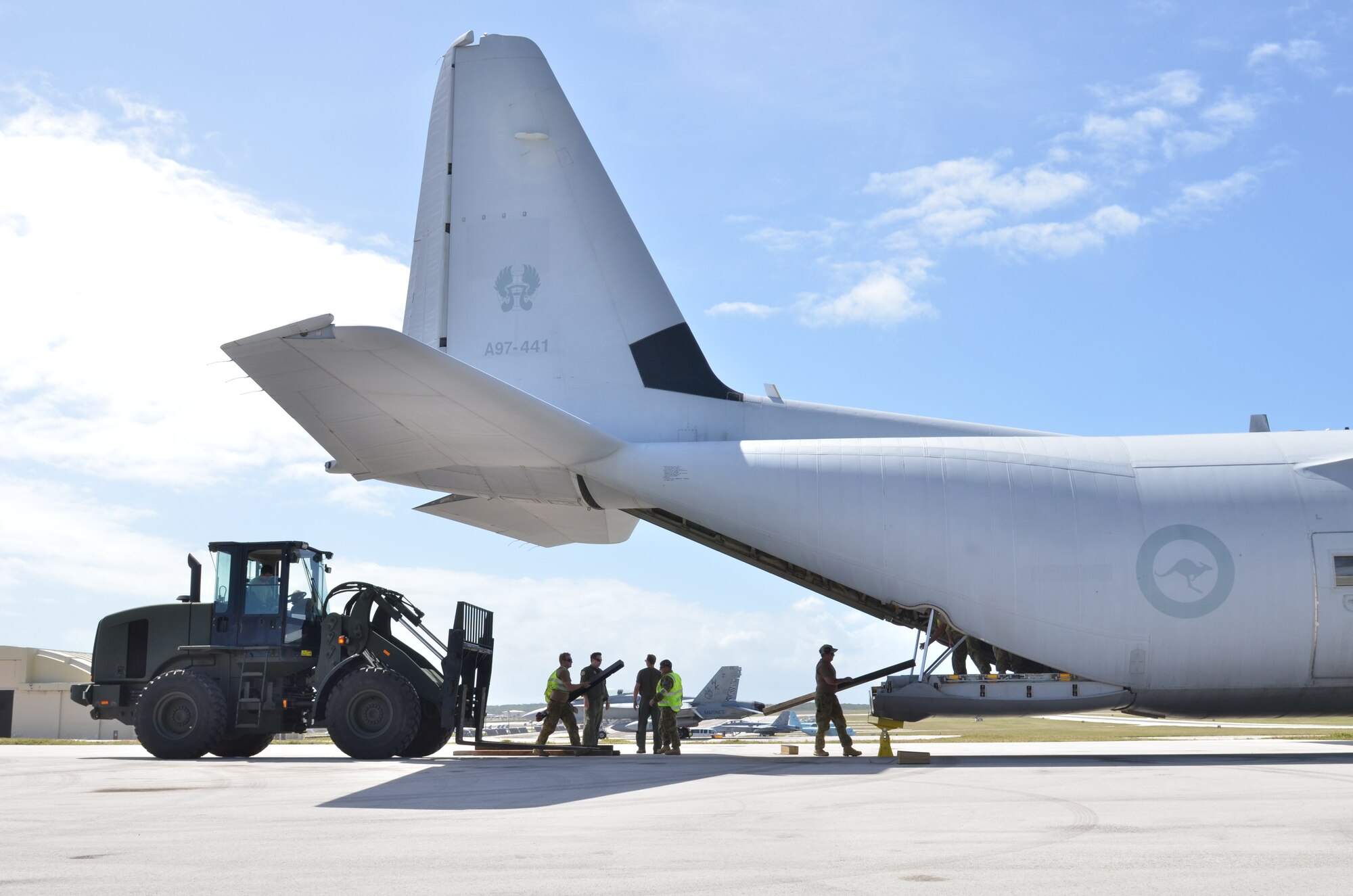Airmen from the 35th Aircraft Maintenance Squadron, Misawa Air Base, Japan, load pallet with a fork lift into a Royal Australian Air force C-130 with the help of Airmen from the 37th Squadron, RAAF Base Richmond, Australia during Cope North Feb. 4, 2013. Cope North is a multilateral Pacific Air Forces-sponsored Field Training Exercise (FTX) conducted annually at Andersen Air Force Base, Guam. The exercise focuses on humanitarian assistance and disaster relief training, air combat tactics and large force employment in an effort to enhance interoperability among U.S., Japan and Australian forces. (U.S. Air Force photo by Staff Sgt. Alex Montes/RELEASED)