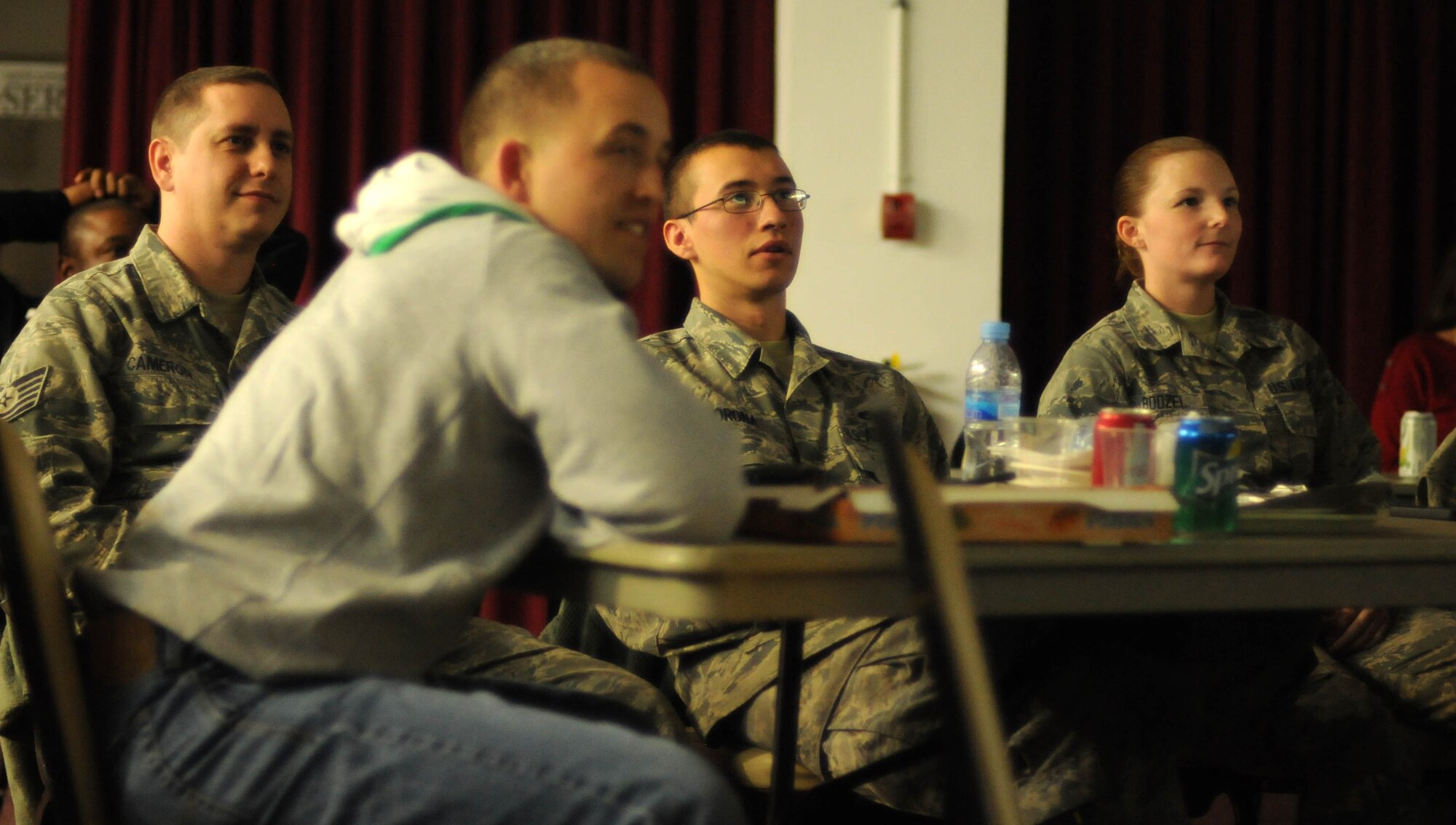 A group of Airmen from the 351st Expeditionary Air Refueling Squadron, watch the Super Bowl at a forward operating location Feb.4, 2013. Hot wings, cheese sticks, pizza and a variety of other foods were available for the big game. Members of the 351st EARS, from the 100th Air Refueling Wing, RAF Mildenhall, England, are deployed to a forward operating location in southwest Europe. The group deployed on Jan. 26 and began conducting aerial refueling missions on Jan. 27 to support French operations in Mali. (U.S. Air Force photo by Staff Sgt. Austin M. May/Released)