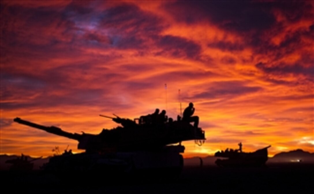 The crews of U.S. Marine Corps M1A1 Abrams tanks prepare for the start of the day’s events while participating in Integrated Training Exercise 13-1 at Twentynine Palms Marine Corps Base, Calif., on Jan. 23, 2013.  The training exercise prepares the Marines for their upcoming deployment.  The Marines are attached to the 1st Tanks, Bravo Company, 3rd Battalion, 4th Marine Regiment.  