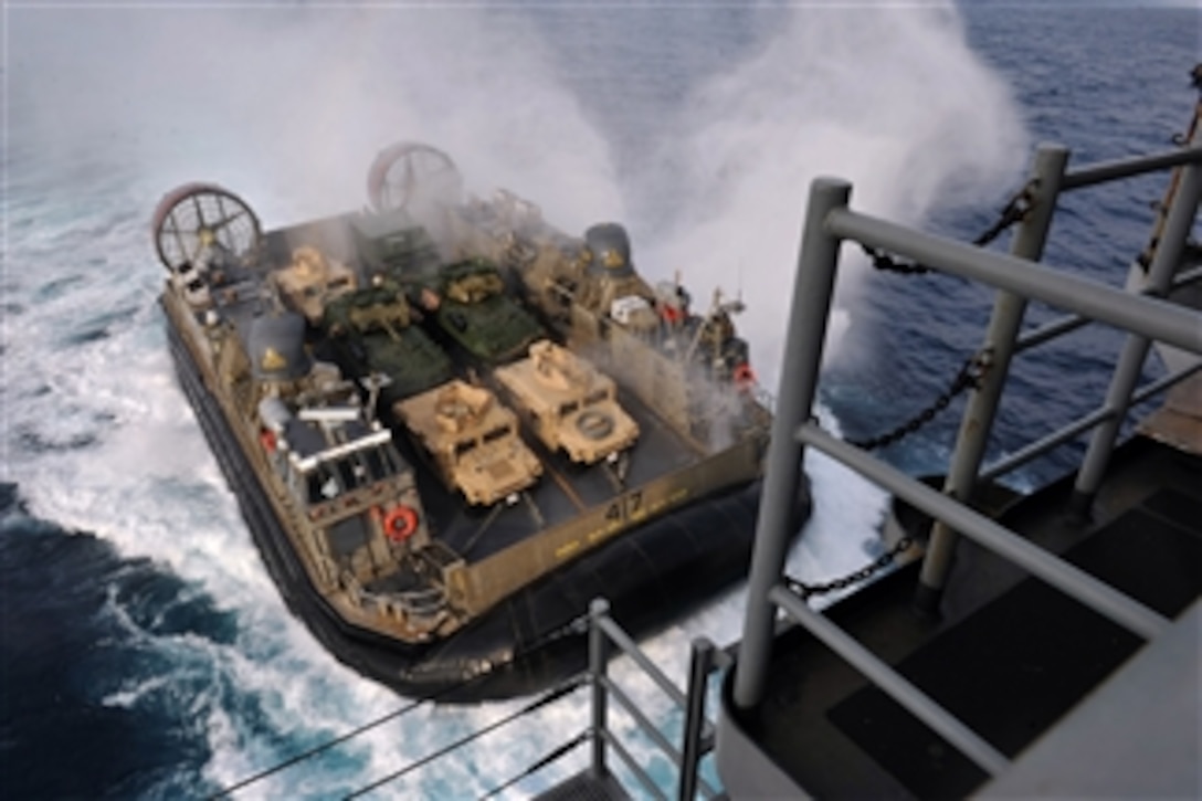 A U.S. Navy Landing Craft Air Cushion, more commonly known as an LCAC, approaches the well deck of the amphibious assault ship USS Bonhomme Richard (LHD 6) as the ship operates in the East China Sea on Feb. 2, 2013.  The Bonhomme Richard Amphibious Ready Group is operating in the U.S. 7th Fleet area of responsibility.  The LCAC is assigned to Naval Beach Unit 7.  