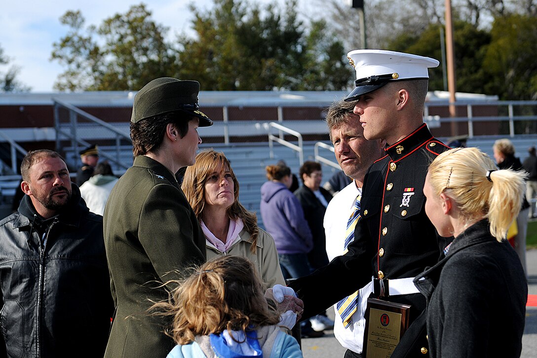 Private First Class David Orley, honor graduate of platoon 2010, shakes the hand of Brig. Gen. Lori Reynolds, Commanding General of Marine Corps Recruit Depot Eastern Recruiting Region Parris Island, while his family stands around him after graduation aboard Parris Island, S.C., Feb.1, 2013. Orley, native and recruited from Naples, Fla., will be able to go home for some much deserved leave while preparing to train to become a Military Police Officer.  (Pfc. John-Paul Imbody)