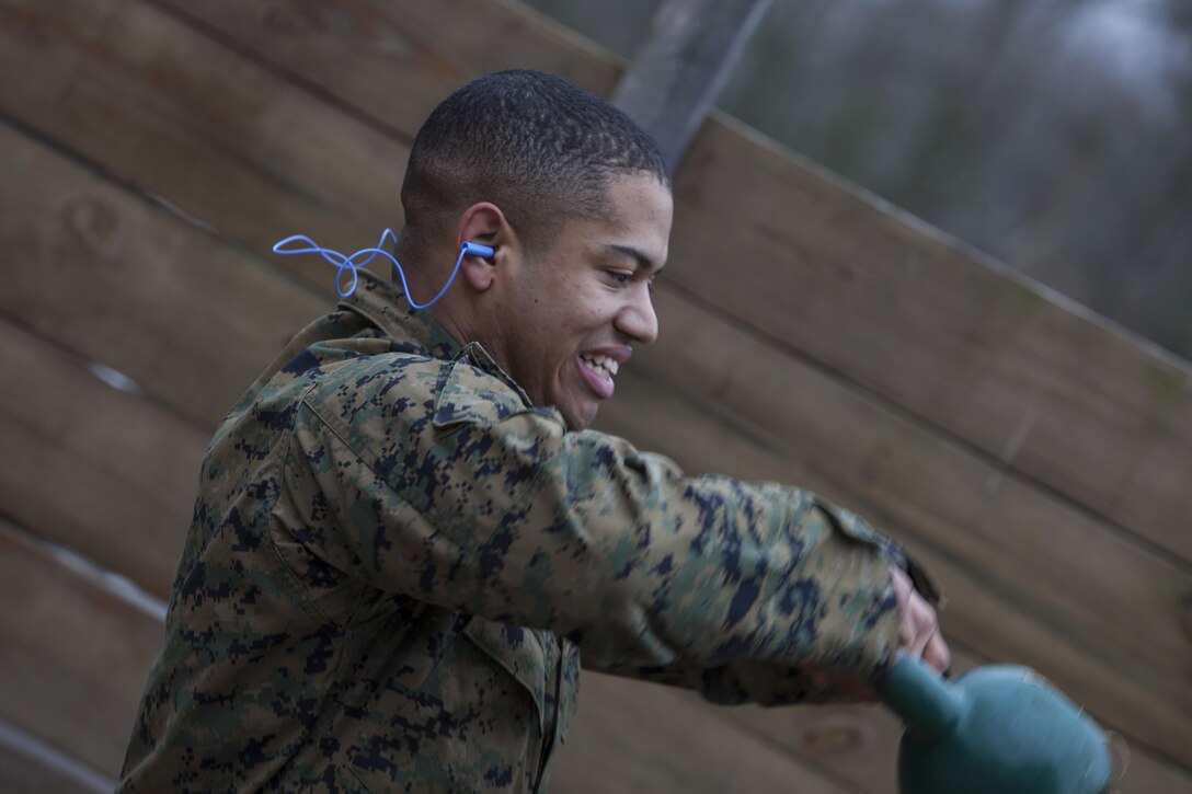 Lance Cpl. Spencer Wallace, second platoon, Guard Company, Marine Barracks Washington, D.C., performs a set of exercises with a kettlebell during a training exercise at Marine Corps Base Quantico, Va., Jan. 30. The Marines conduct monthly, advanced CMP live-fire exercises in Quantico.  The training evolutions maintain their high levels of proficiency with the M4 carbine, M9 handgun and M1014 shotgun.  The Guard Marines fire on the move while engaging multiple targets, and utilize stress drills to sharpen their tactics.