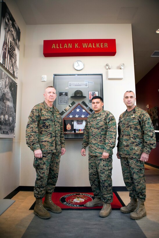 MARINE CORPS RECRUIT DEPOT, SAN DIEGO -- Lt. Gen. Steven A. Hummer, commander of Marine Forces Reserve and Marine Forces North, Sgt. Miguelange G. Madrigal, a radio chief with Supporting Arms Liaison Team G, 1st Air Naval Gunfire Liaison Company, I Marine Expeditionary Force Headquarters Group, and Sgt. Maj. James E. Booker, sergeant major of MARFORRES and MARFORNORTH, gather inside the Staff Sgt. Allan K. Walker building aboard Marine Corps Recruit Depot, San Diego, Jan. 31, 2013. The building and shadow box behind them were constructed in honor of Walker, who was killed in Ramadi, Iraq, in 2004.  Walker served under Booker in Iraq and was also Madrigal’s drill instructor in 2003. (U.S. Marine Corps photo by Cpl. Marcin Platek/Released)

