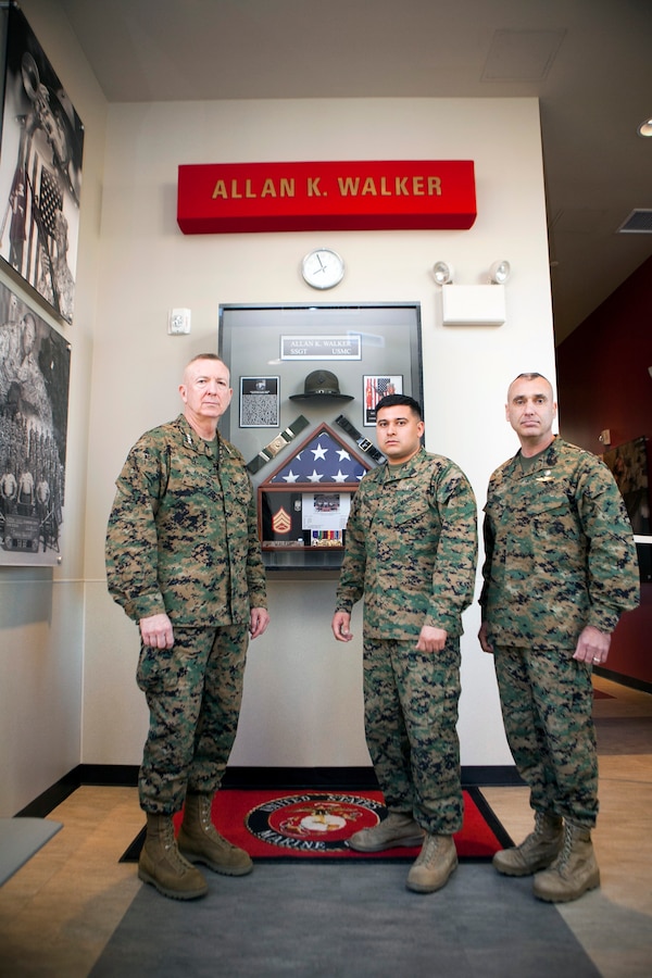 MARINE CORPS RECRUIT DEPOT, SAN DIEGO -- Lt. Gen. Steven A. Hummer, commander of Marine Forces Reserve and Marine Forces North, Sgt. Miguelange G. Madrigal, a radio chief with Supporting Arms Liaison Team G, 1st Air Naval Gunfire Liaison Company, I Marine Expeditionary Force Headquarters Group, and Sgt. Maj. James E. Booker, sergeant major of MARFORRES and MARFORNORTH, gather inside the Staff Sgt. Allan K. Walker building aboard Marine Corps Recruit Depot, San Diego, Jan. 31, 2013. The building and shadow box behind them were constructed in honor of Walker, who was killed in Ramadi, Iraq, in 2004.  Walker served under Booker in Iraq and was also Madrigal’s drill instructor in 2003. (U.S. Marine Corps photo by Cpl. Marcin Platek/Released)

