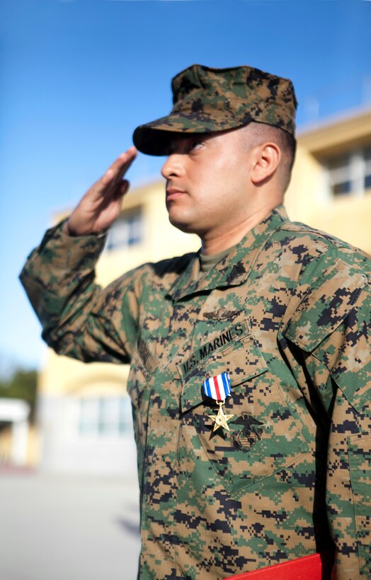 MARINE CORPS RECRUIT DEPOT, SAN DIEGO -- Sgt. Miguelange G. Madrigal, a radio chief with Supporting Arms Liaison Team G, 1st Air Naval Gunfire Liaison Company, I Marine Expeditionary Force Headquarters Group, salutes Lt. Gen. Steven A. Hummer, commander of Marine Forces Reserve and Marine Forces North, after being awarded a Silver Star Medal aboard Marine Corps Recruit Depot, San Diego, Jan. 31, 2013. Madrigal was awarded the nation’s third highest honor for his actions as a member of a squad patrol that was pinned down by insurgent fire. On Feb. 15, 2010, he repelled an enemy attack, rushed to save a fellow Marine, called in multiple fire-support missions, and called in a casualty evacuation. (U.S. Marine Corps photo by Cpl. Marcin Platek/Released)