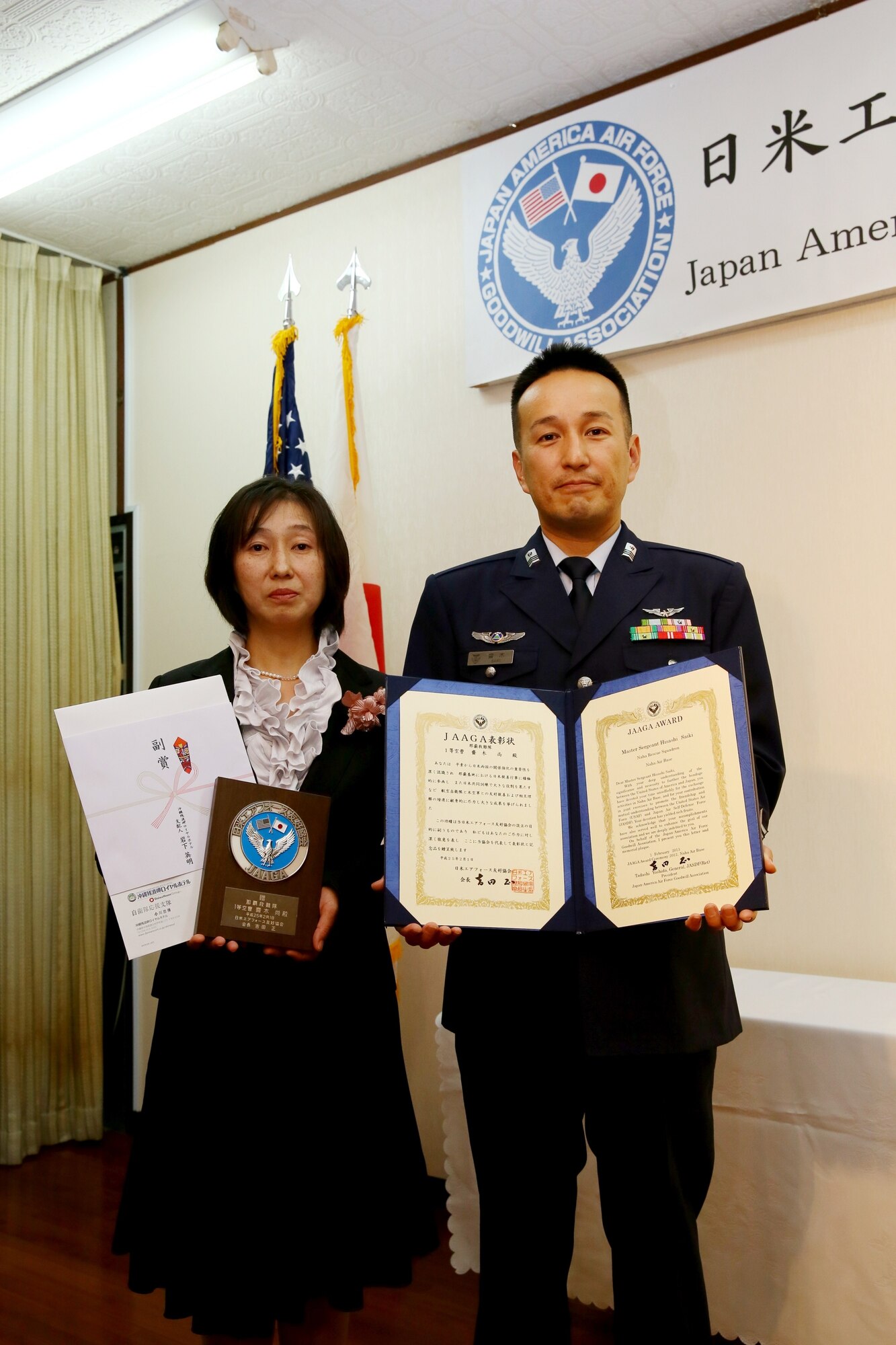 Japan Air Self Defense Force Master Sgt. Hisashi Saiki, with his wife, Emiko, is recognized during the 15th annual Japan-America Air Force Goodwill Association award ceremony and reception at Naha Air Base, Japan, Feb. 1, 2013. Saiki and U.S. Air Force Senior Master Sgt. Robert Miller, from the 718th Aircraft Maintenance Squadron, were recognized at the event for their work to strengthen the bonds between the U.S. and Japan. (Japan Air Self Defense Force photo/Chief Master Sgt. Tatsuya Hosobuchi)
