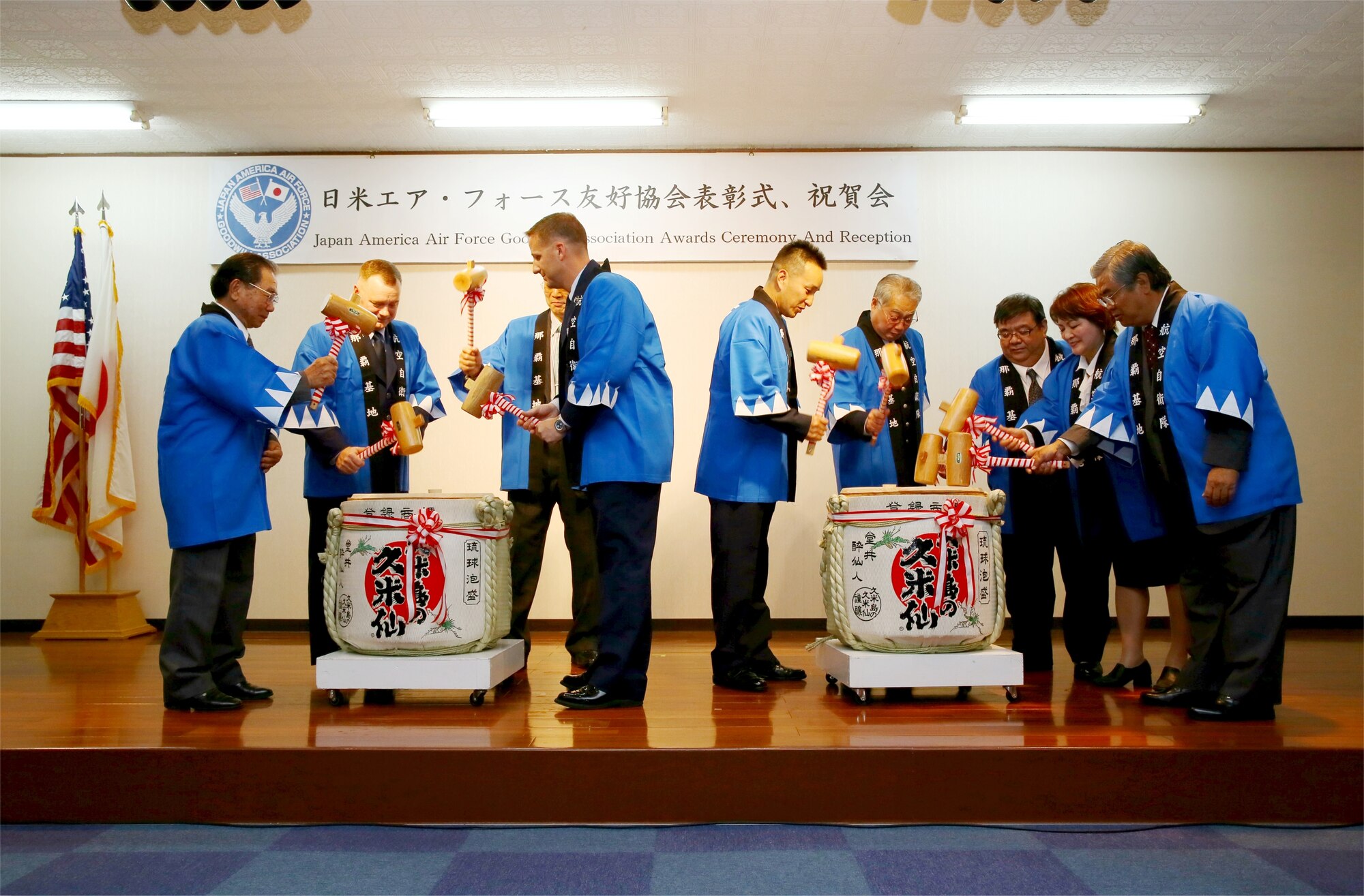 Ceremony participants use wooden mallets to break the tops of Japanese sake barrels to commemorate the 15th annual Japan-America Air Force Goodwill Association ceremony at Naha Air Base, Japan, Feb. 1, 2013. The ceremony and reception recognized Senior Master Sgt. Robert Miller and Japan Air Self Defense Force Master Sgt. Hisashi Saiki for working to strengthen the bonds between the U.S. and Japan. (Japan Air Self Defense Force photo/Chief Master Sgt. Tatsuya Hosobuchi)
