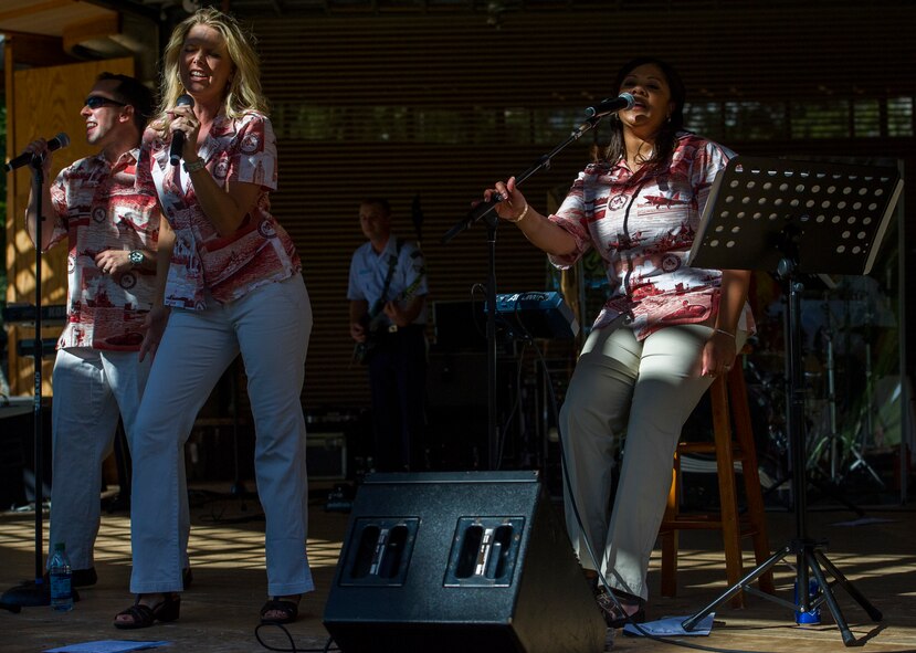 (From left) Senior Airman Devin Rivas-Martin, Master Sgt. Lara Murdzia, and Tech. Sgt. Tamiko Boone, vocalists from the Pacific Air Forces Band of the Pacific’s “Hana Hou” ensemble from Joint Base Pearl Harbor-Hickam, Hawaii, perform Feb. 3 on the bandstand at Kapiolani Park in Honolulu, Hawaii, during the Vietnamese New Year celebration. Known in Vietnamese by its shortened name, “T?t Nguyên Ðán,” the celebration marks the first day of the lunar new year and serves as an opportunity for Vietnamese-Americans to worship ancestors, be with family, and forget the troubles of the past year while hoping for a better new year. (U.S. Air Force photo by Staff Sgt. Nathan Allen)