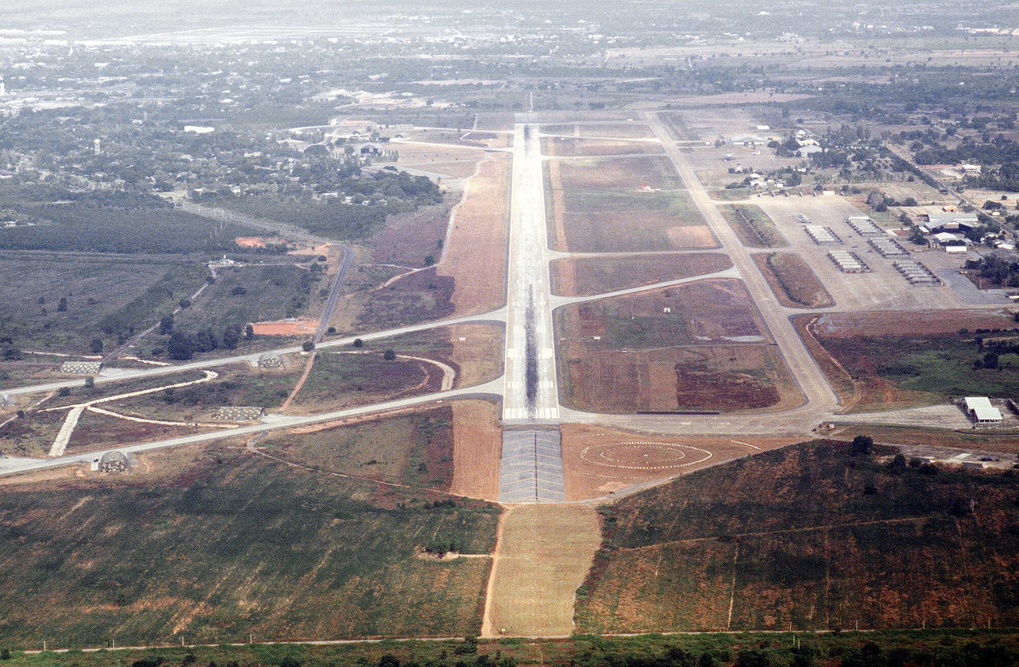 This aerial photo taken Nov. 4, 1988, shows the approach end of the primary runway at Korat Royal Thai Air Base, Thailand, during Exercise Checkered Flag. Korat Air Base was one of the Southeast Asia air bases used to support the U.S. evacuation from Saigon, South Vietnam, April 29-30, 1975. (U.S. Air Force photo/Master Sgt. Michael Harrington)