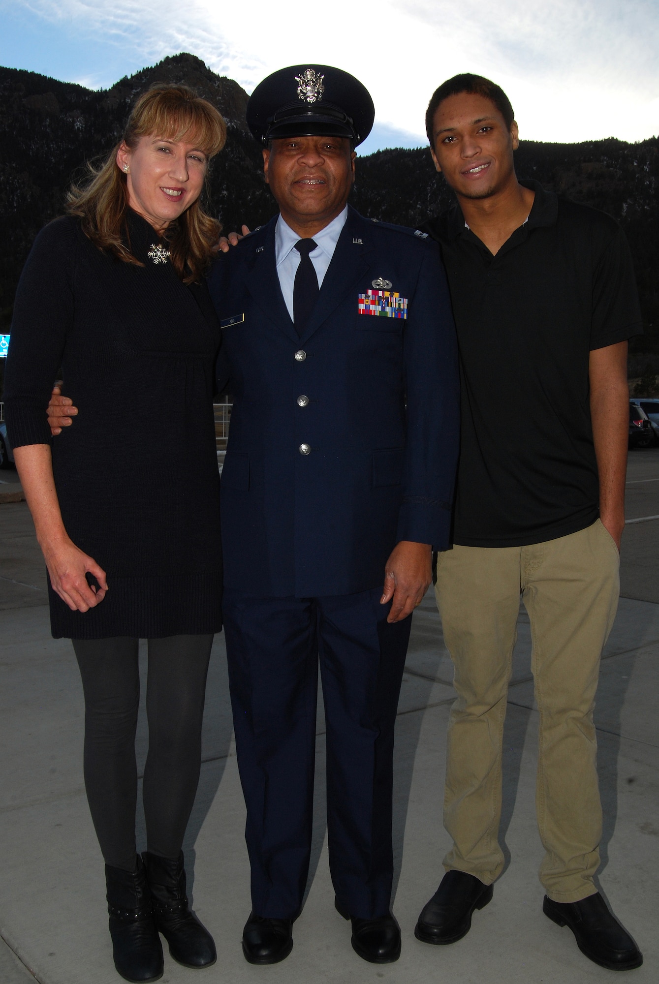 Retired Capt. Jimmie Fox poses for a photo outside the Air Force Academy with his wife, Ann Doolan-Fox, and their son, Ryan, Feb. 4, 2013. Fox received a Vietnam Service Medal from Brig. Gen. Dana Born, the Academy's dean of the faculty, for his role in supporting the U.S. evacuation of Saigon, South Vietnam, April 29-30, 1975. (U.S. Air Force photo/Don Branum)