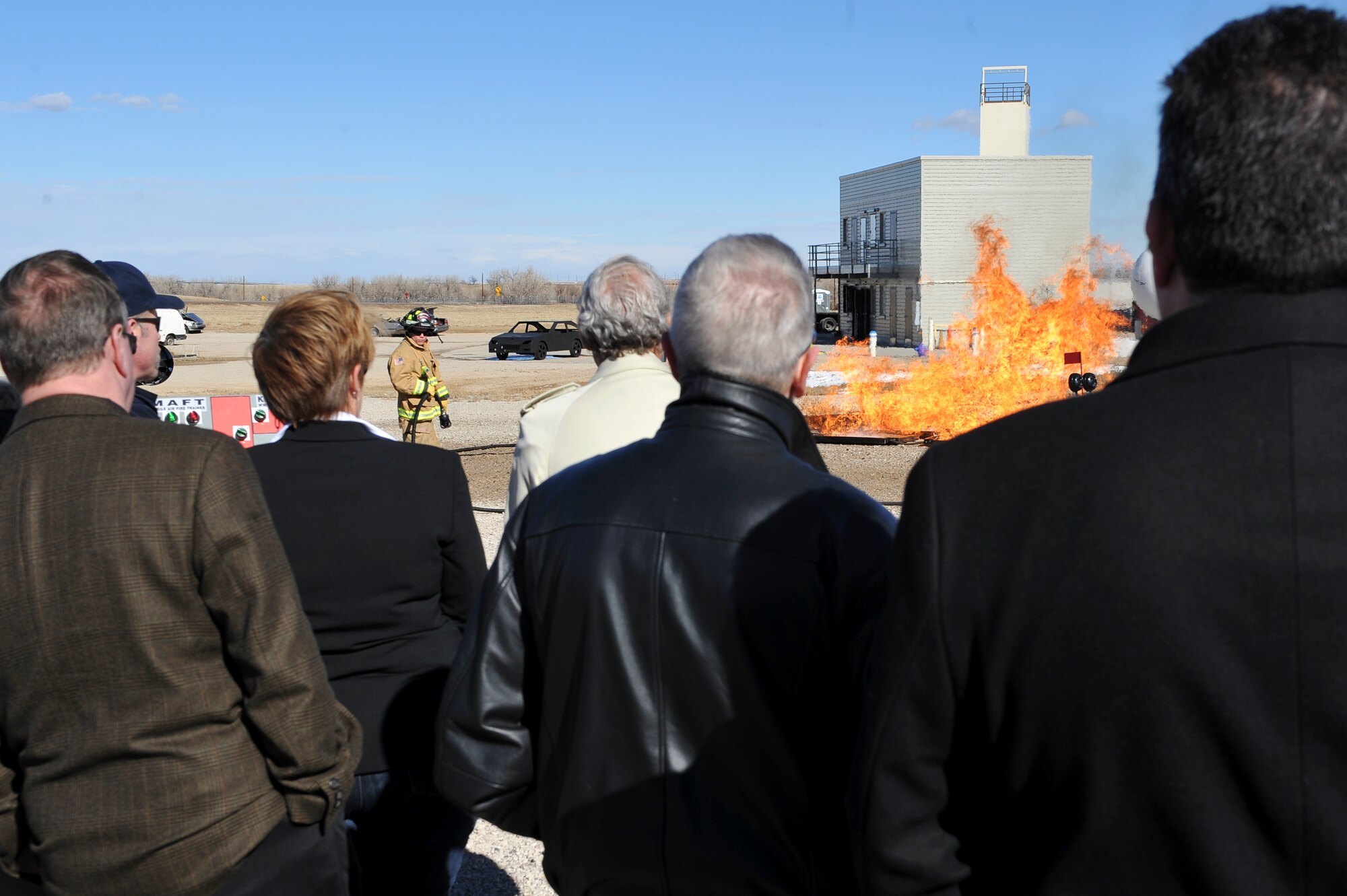 Participants of Mayors’ Day view a demonstration by the 460th Civil Engineer Squadron firefighters Feb. 1, 2013, at the Buckley Air Force Base fire training ground. This was one of several demonstrations given to local Colorado mayors during Mayors’ Day. (U.S. Air Force photo by Airman 1st Class Phillip Houk/Released)