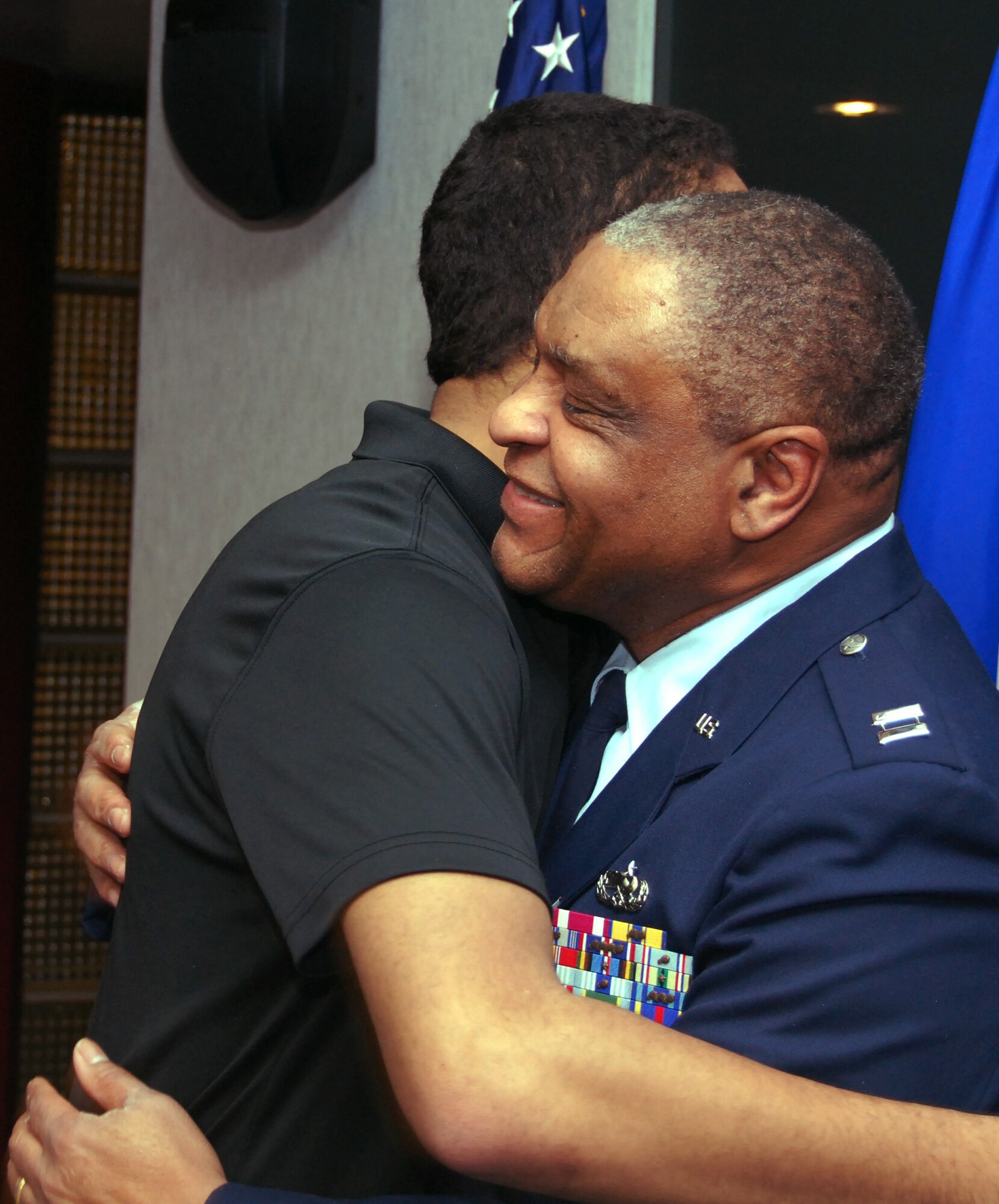 Retired Capt. Jimmie Fox hugs his son, Ryan, after receiving a Vietnam Service Medal during a ceremony at the Air Force Academy's Visitor Center Feb. 4, 2013. Fox enlisted into the Air Force in 1973 and earned a commission in 1981. His first post-commission assignment was at the Academy, where Ryan, now 16, was born. (U.S. Air Force photo/Don Branum)